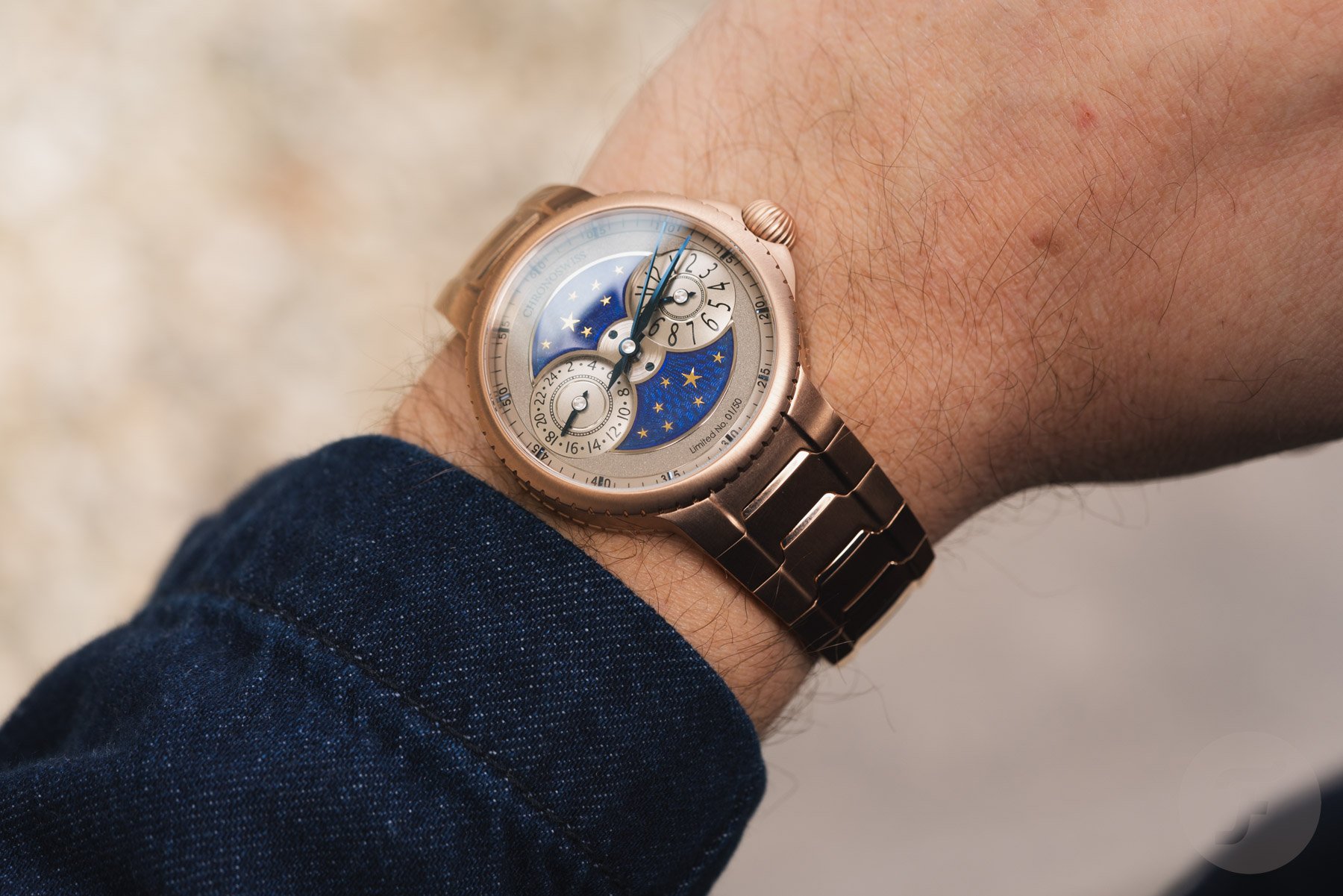 rose gold Chronoswiss Pulse GMT on wrist, over-shoulder shot