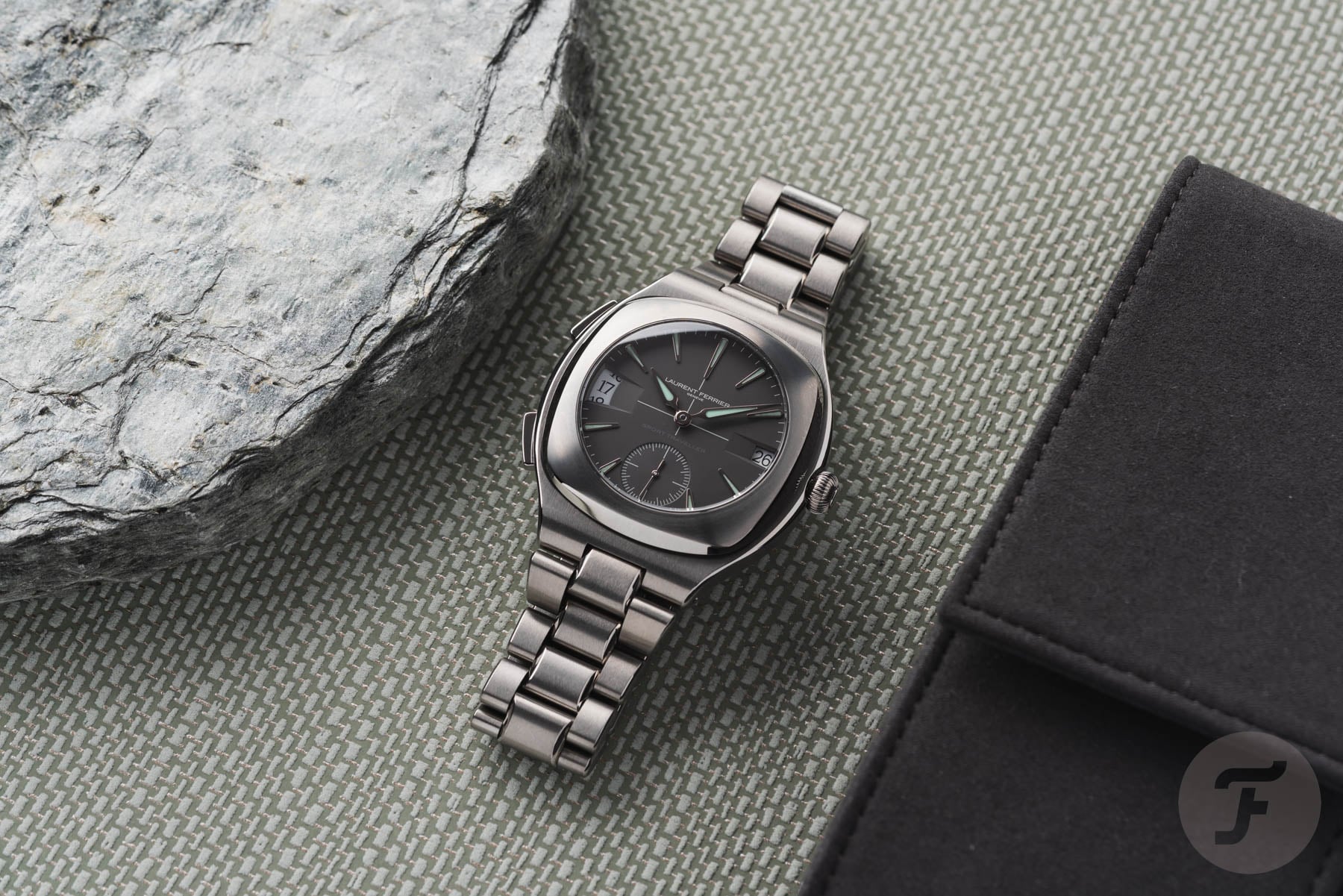Laurent Ferrier Sport Traveller flat-lay between stone and watch pouch