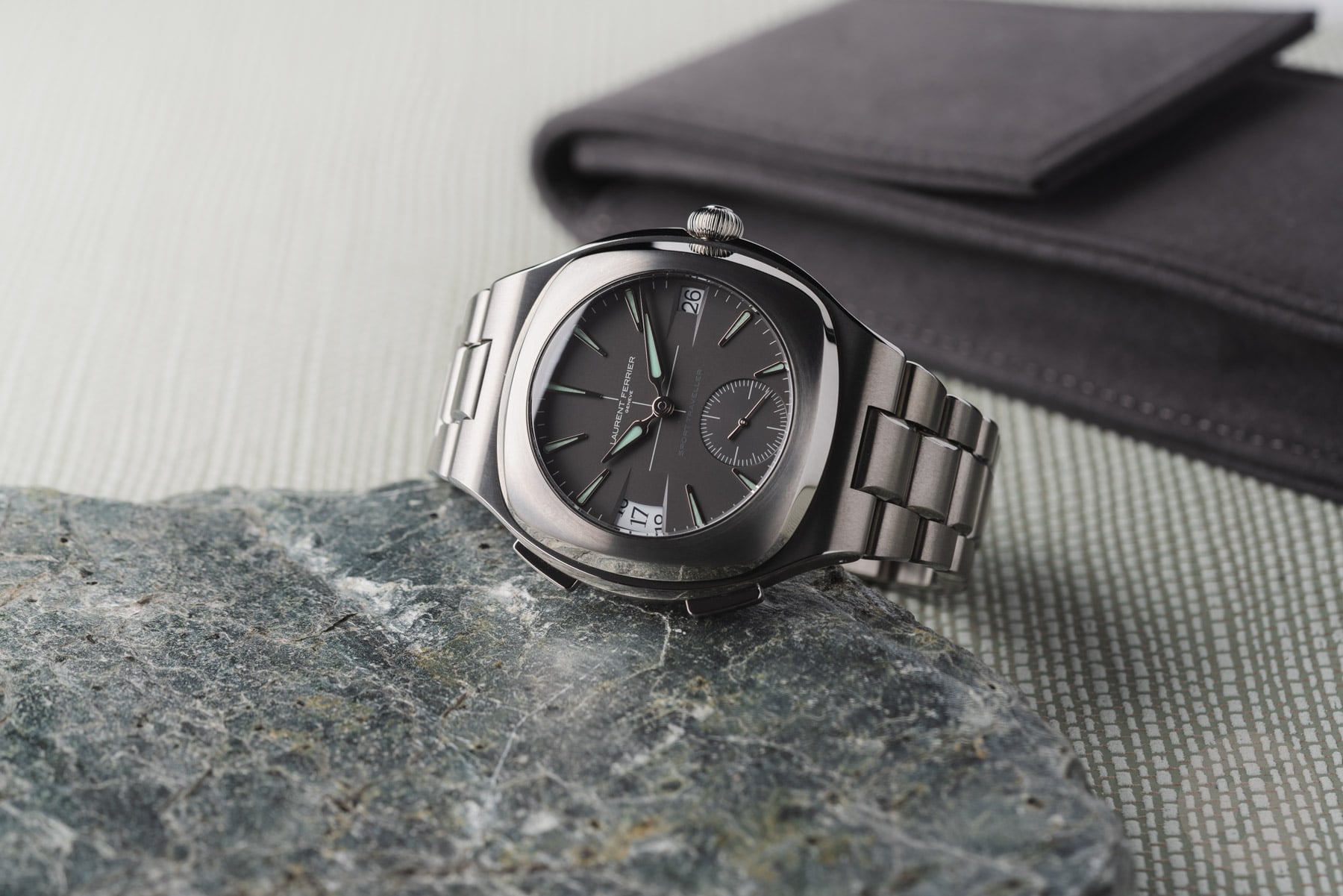 Laurent Ferrier Sport Traveller on its side, crown up, propped up on stone