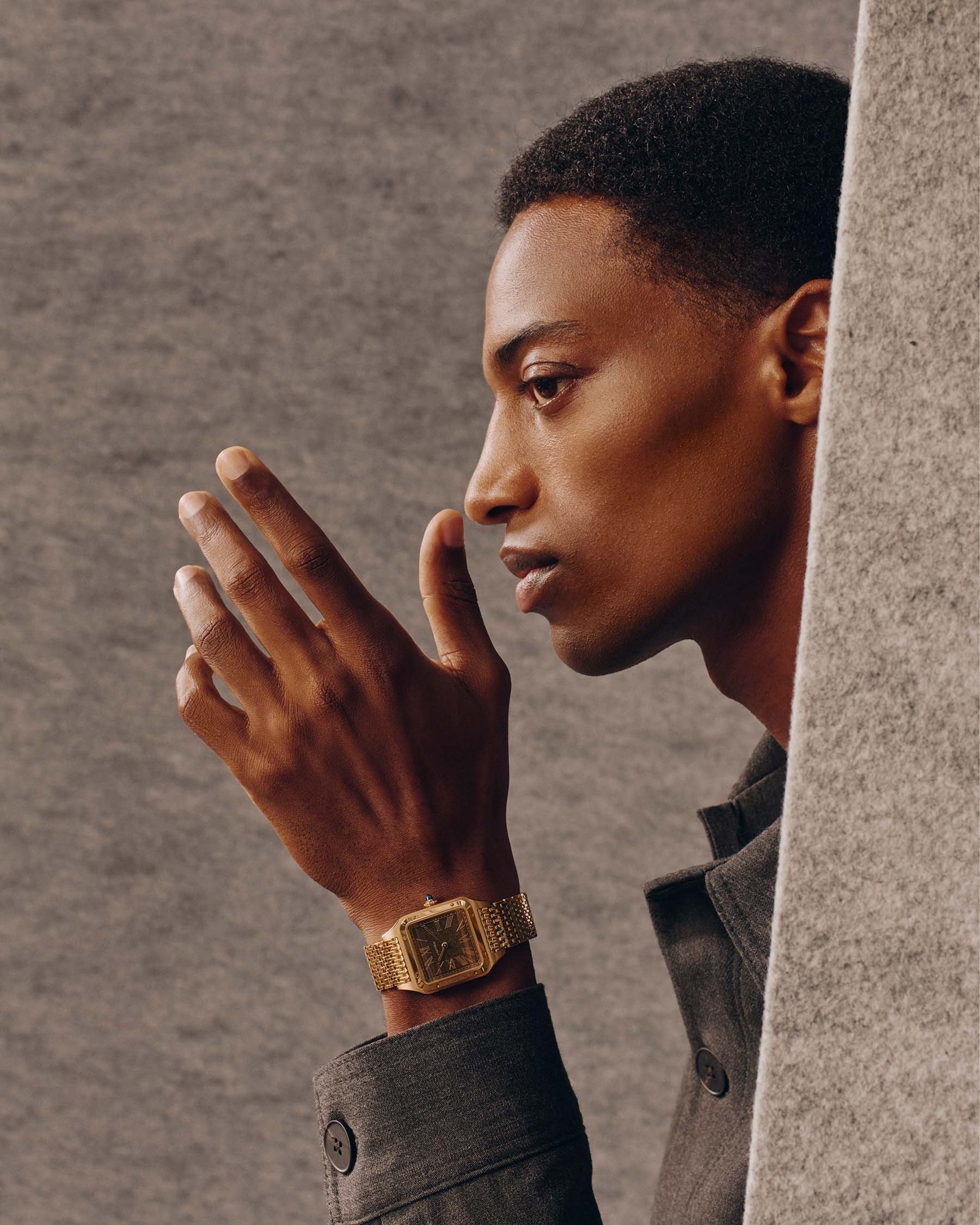 gold Cartier Santos-Dumont with bracelet and obsidian dial on wrist