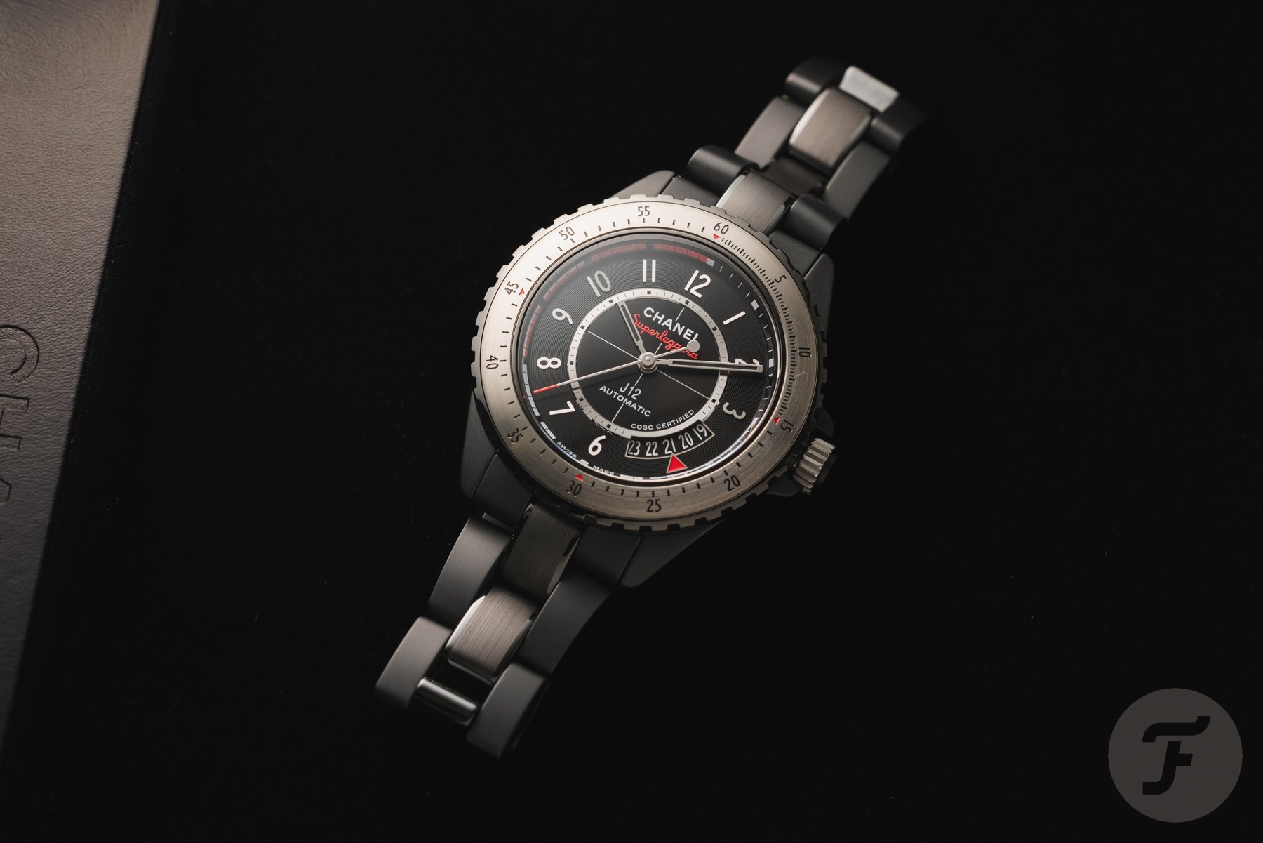 Flat-lay of the Chanel J12 Superleggera Caliber 12.1 on black background