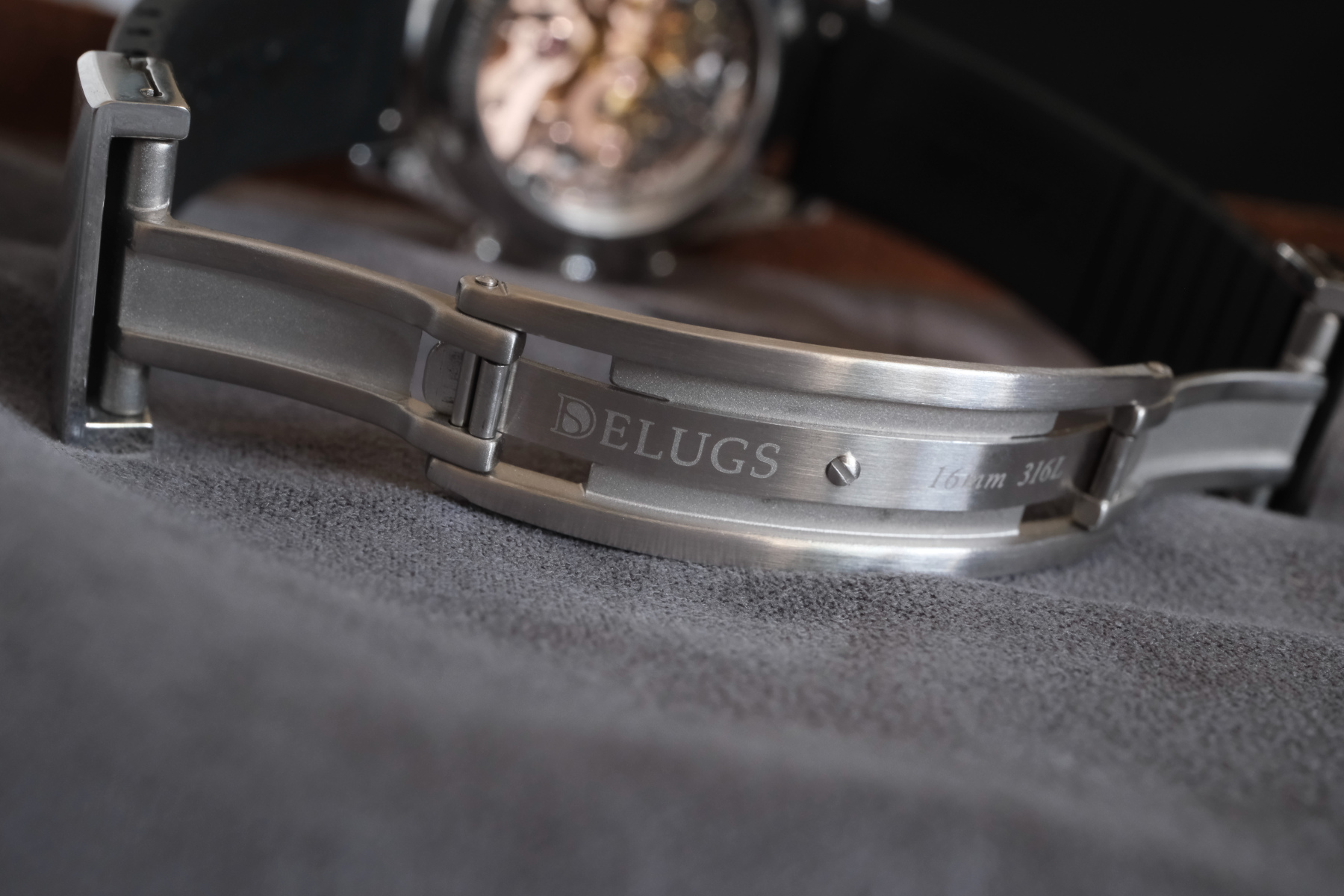 Delugs Micro-Adjust CTS Deployant Clasp closeup, opened to show the branding and spring closure mechanism