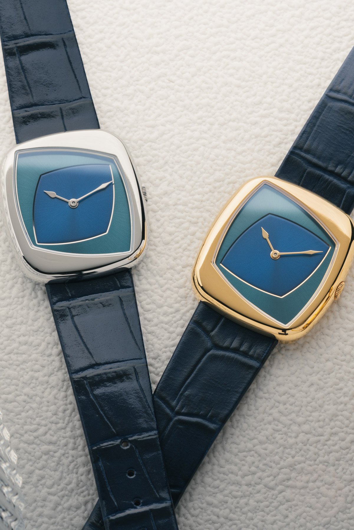Dennison Collectability Oblique Enigma steel and gold PVD variants side by side, flat-lay
