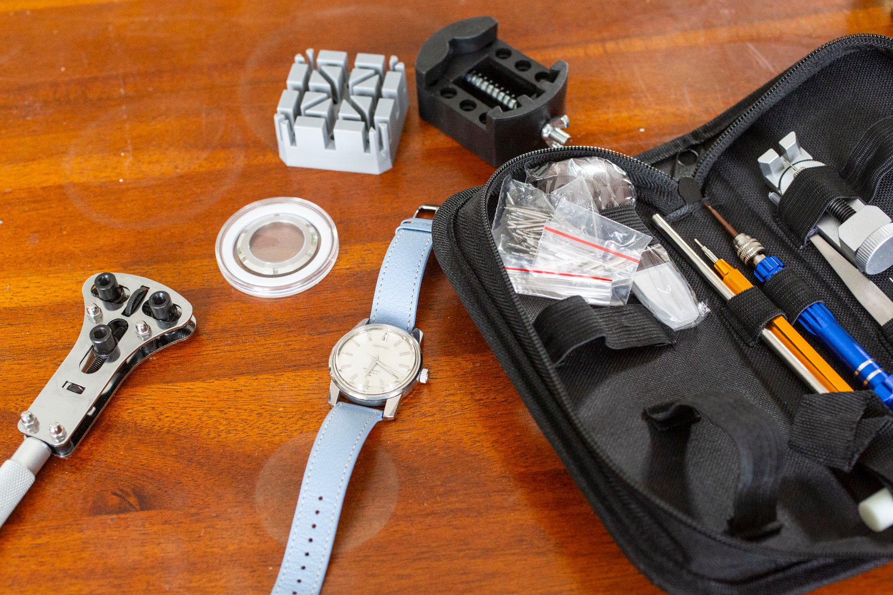 King Seiko 44-9990 flat lay with tool kit and display dase back