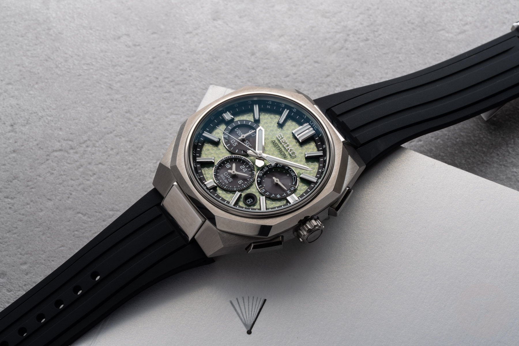 Seiko Astron GPS Solar Dual-Time Chronograph Crystal Green (HAB005) on rubber strap, flat-lay