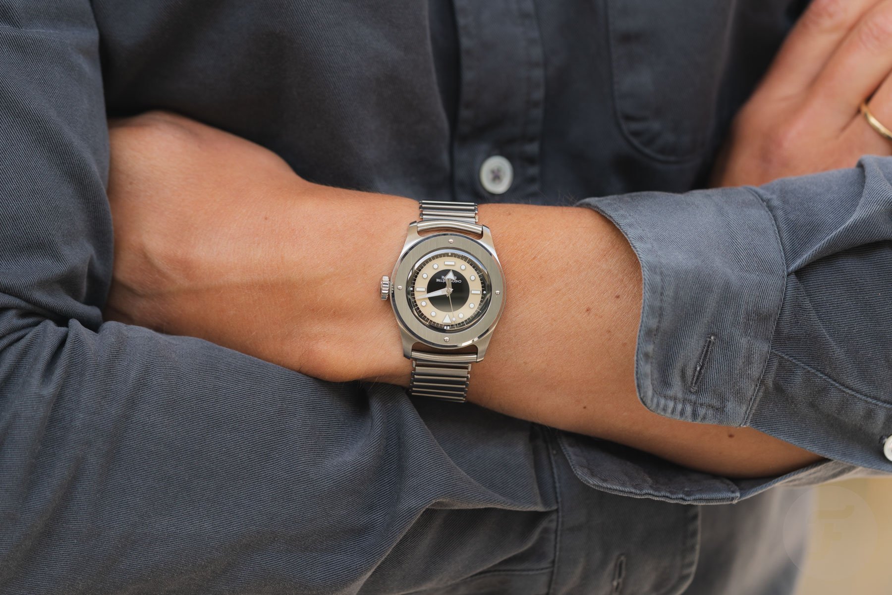 tuxedo-dial Serica 7505 on wrist, arms folded