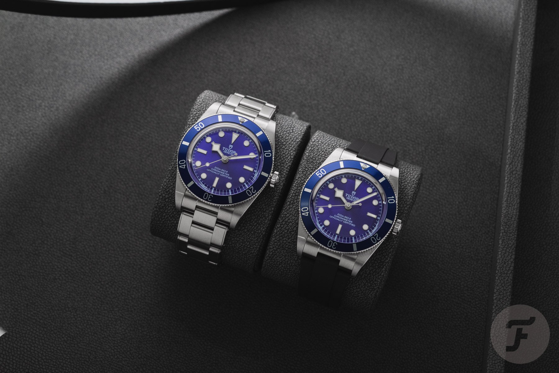 blue Tudor Black Bay 54 models with bracelet and strap side by side on watch cushions