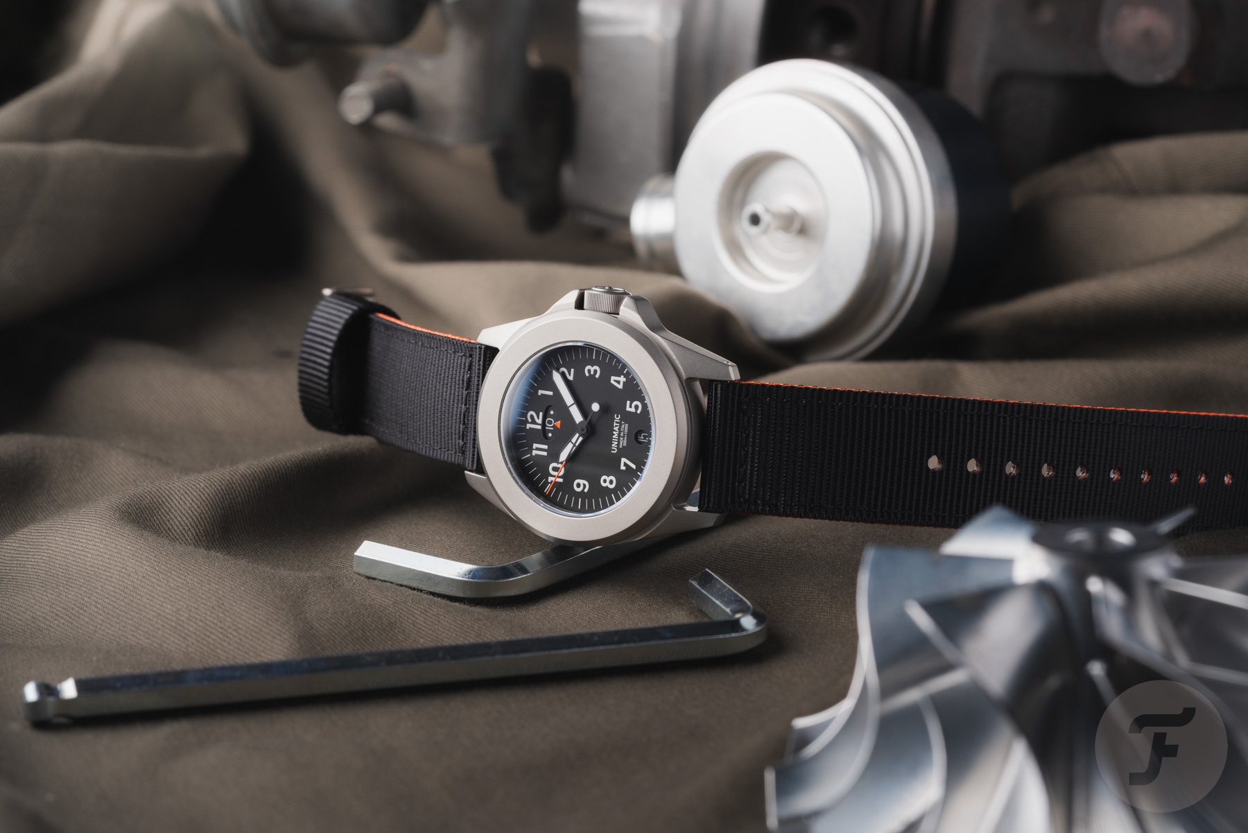Unimatic Modello Quattro UT4-U-TI-GMT on its side, crown up