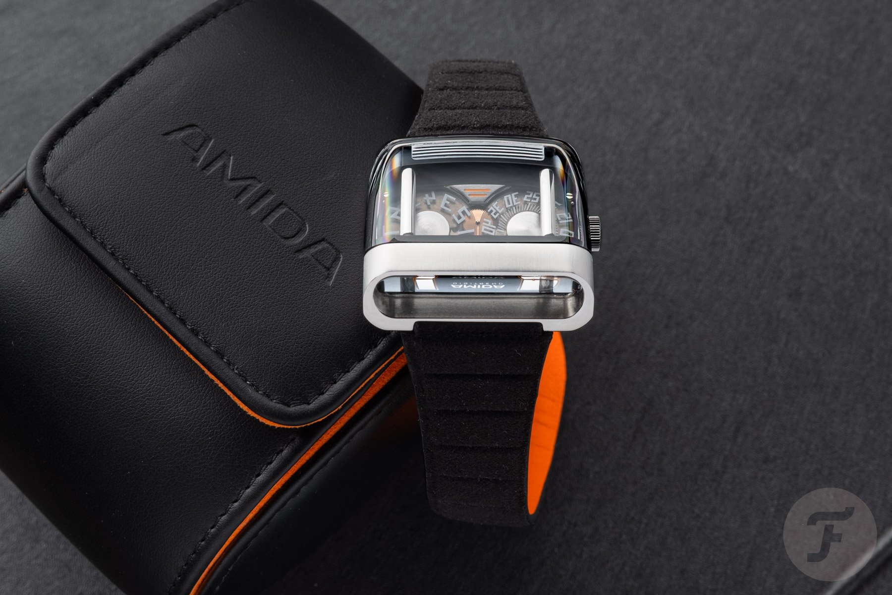 Amida Digitrend OSII Black hanging off watch roll, diagonal view from top
