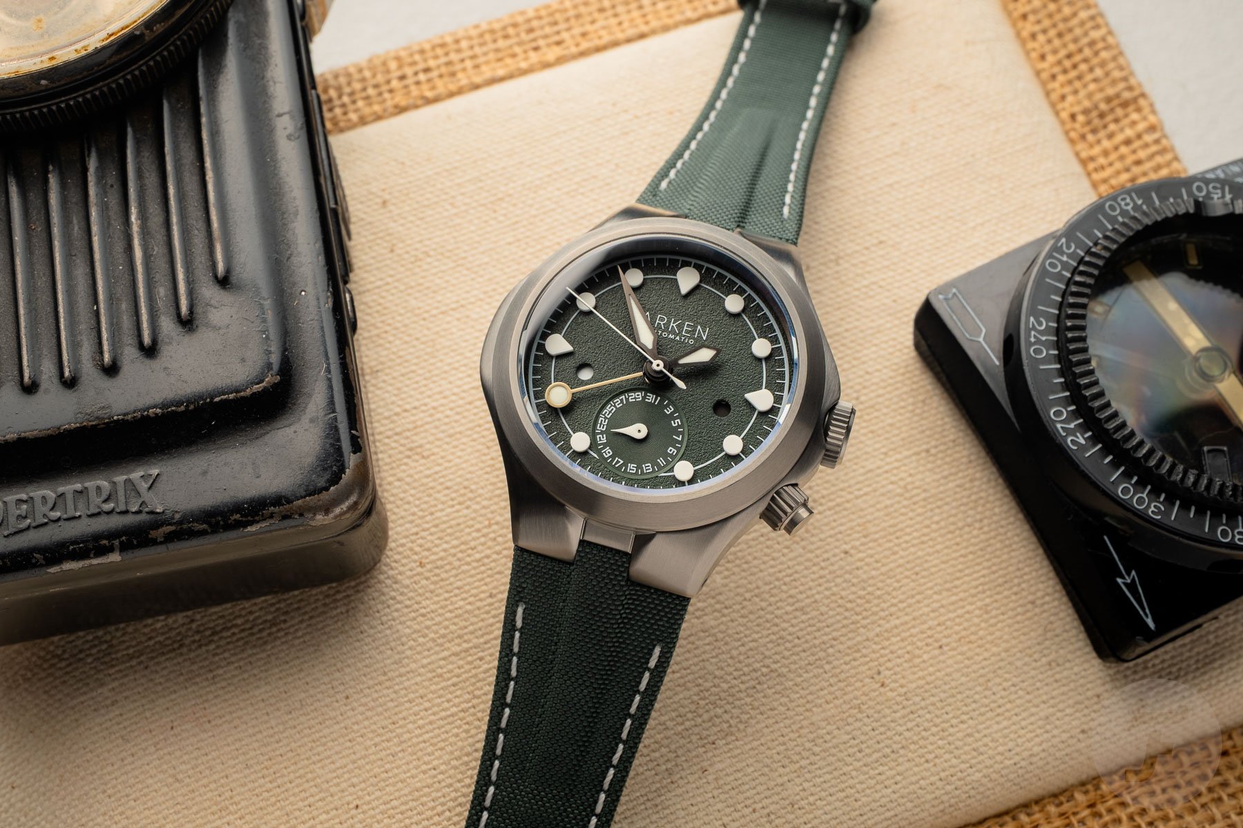 Arken Alterum Sage Grey GMT between compass and light