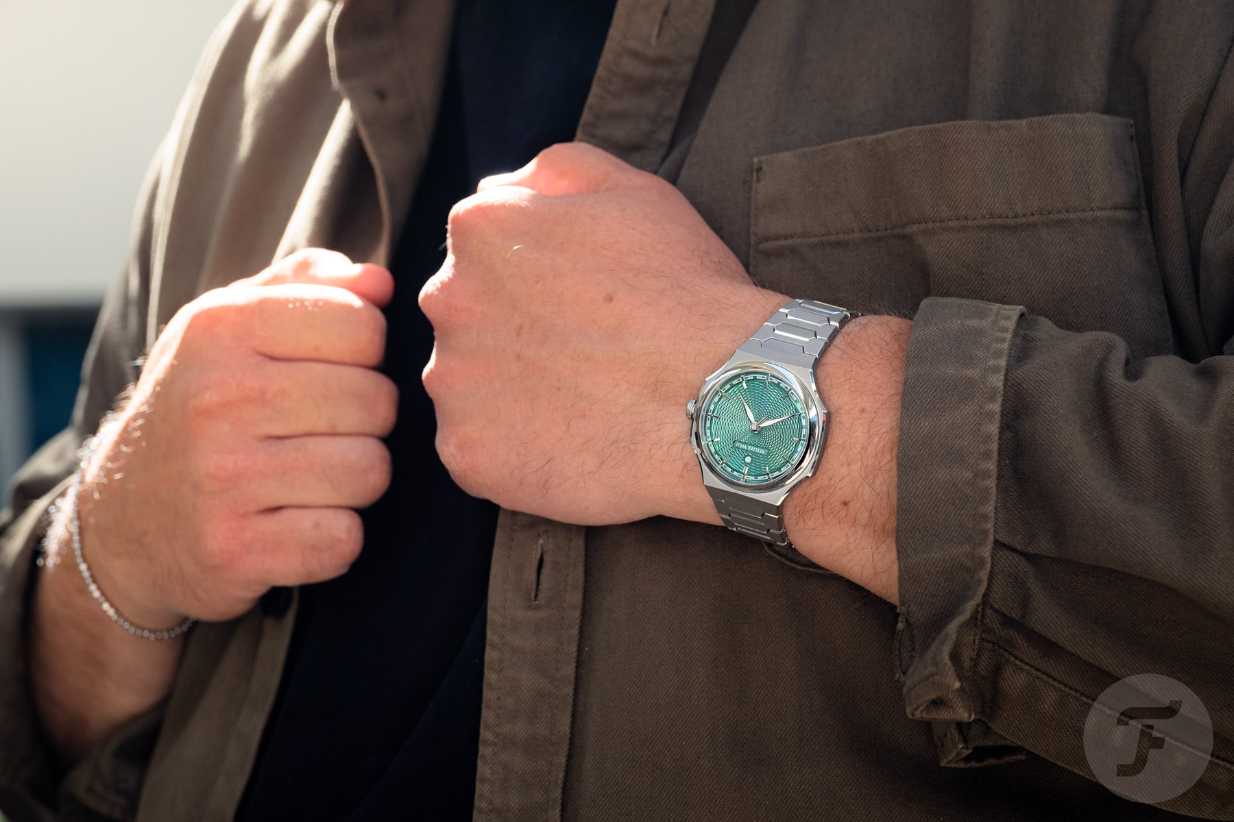Atelier Wen Perception V3 Yún on wrist, hands on lapel