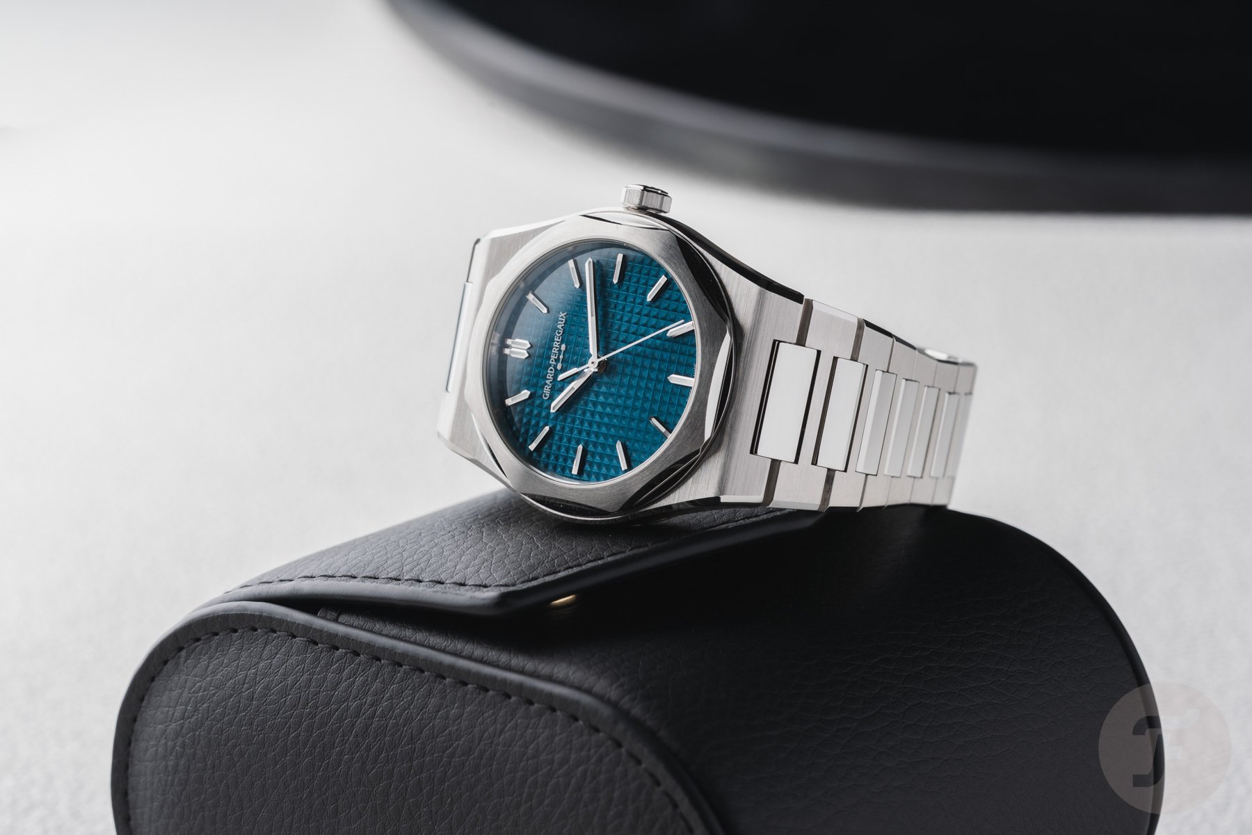 steel Girard-Perregaux Laureato Fifty on its side on top of watch roll, header image