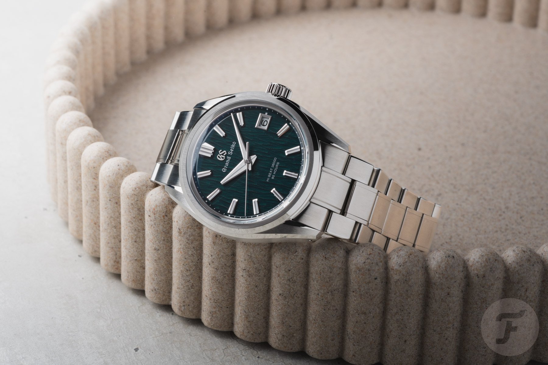 Grand Seiko Evolution 9 Hi-Beat SLGH033 on its side, on edge of tray