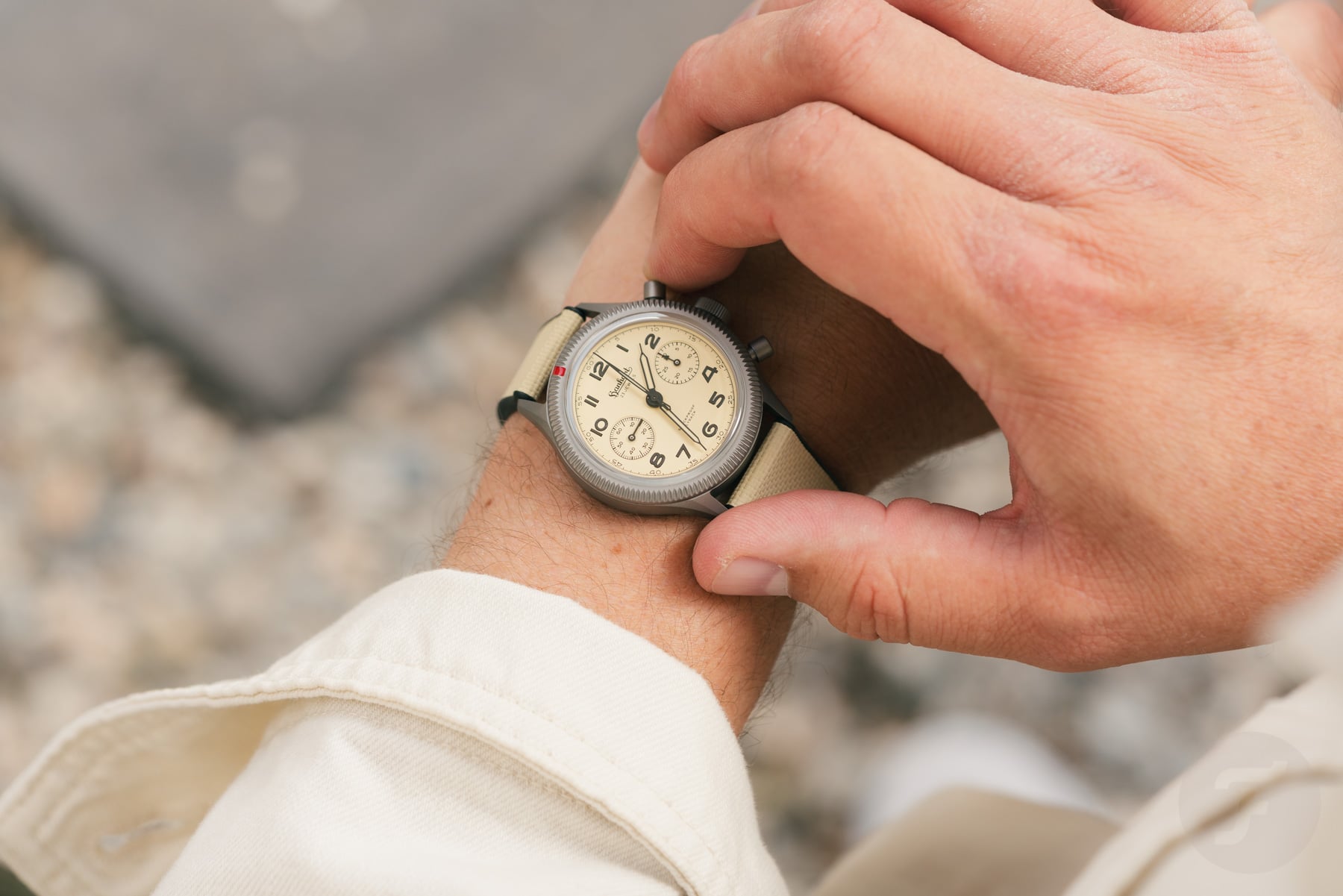 Hanhart 417 TI Desert Pilot on wrist, finger on pusher
