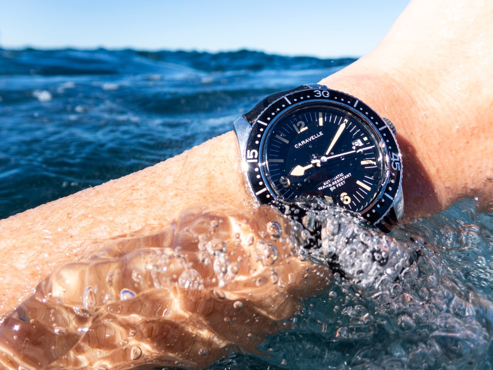Caravelle Sea Hunter on wrist, emerging from water