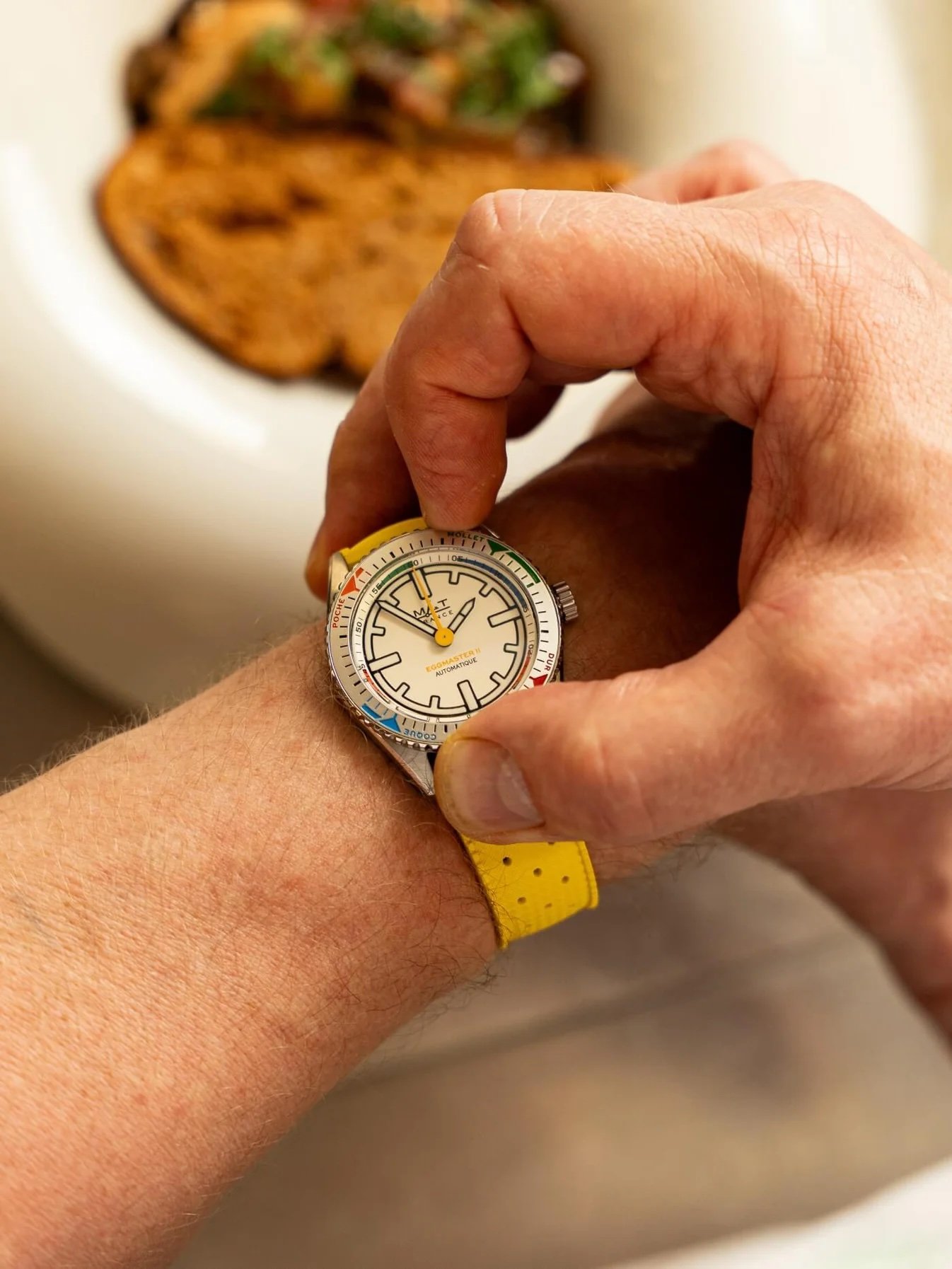 MAT Egg Master II on wrist, fingers on bezel