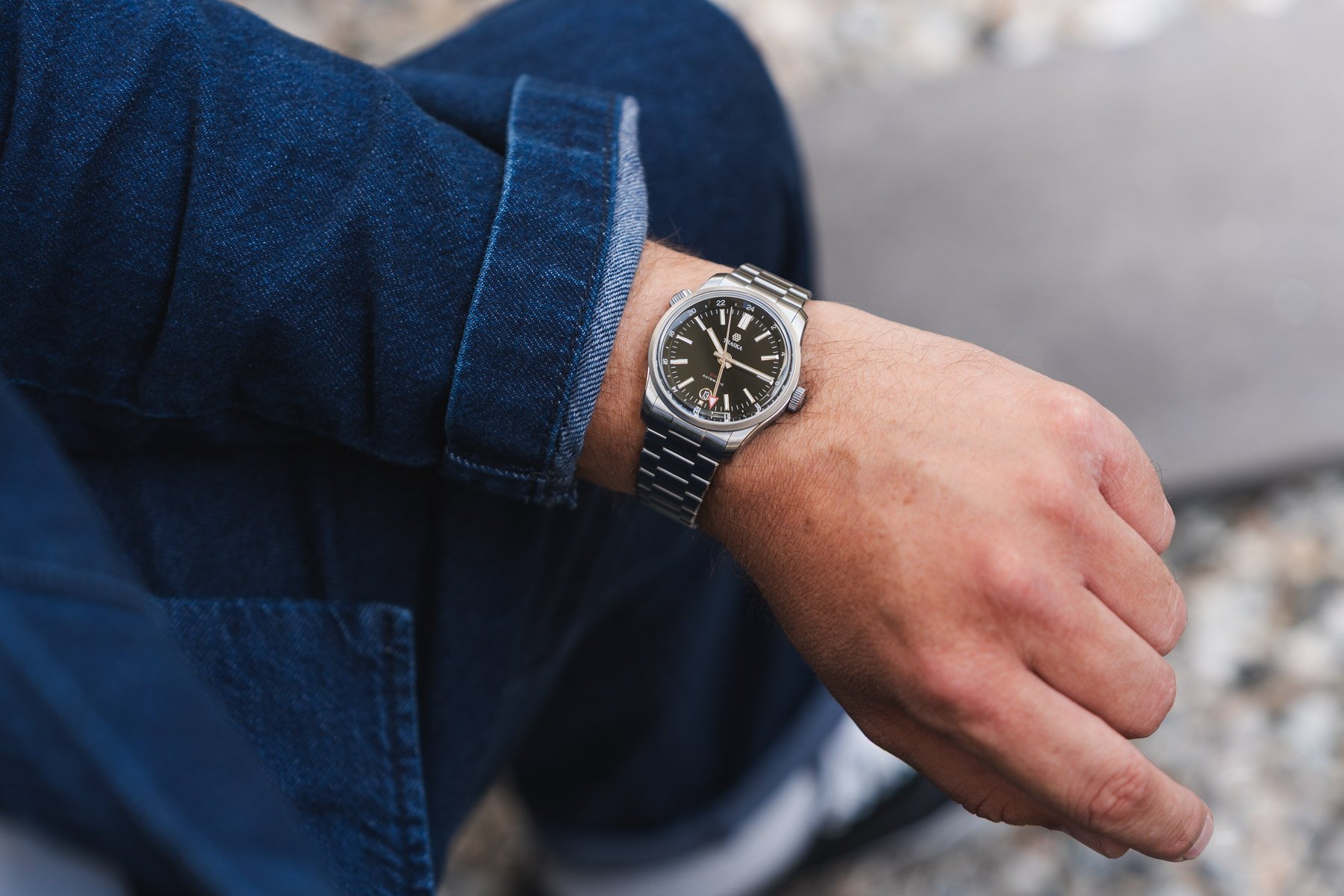 Traska Venturer GMT Carbon Black on wrist, over-shoulder shot