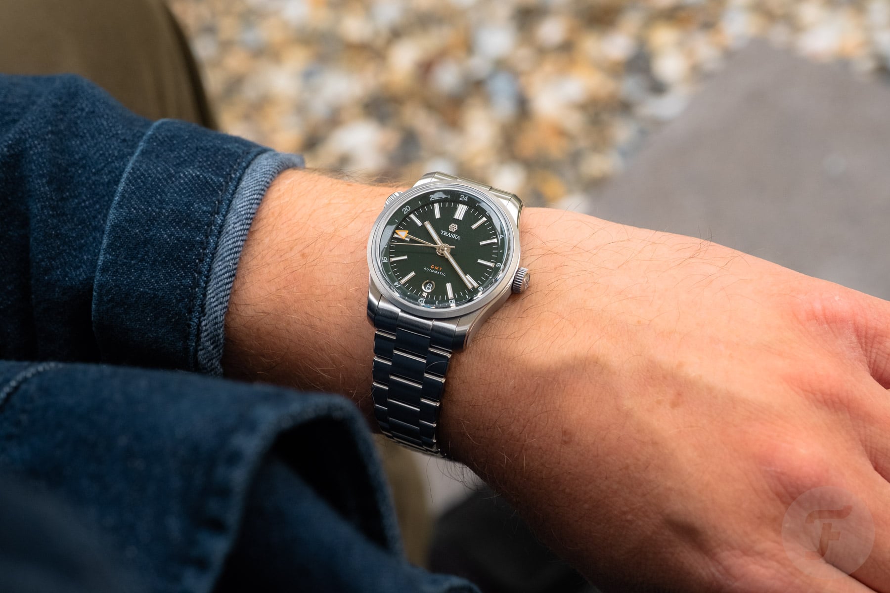 Traska Venturer GMT Bottle Green on wrist, over-shoulder shot