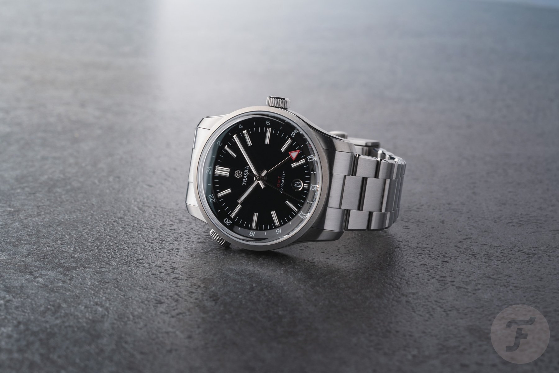 Traska Venturer GMT Carbon Black on its side, crown up