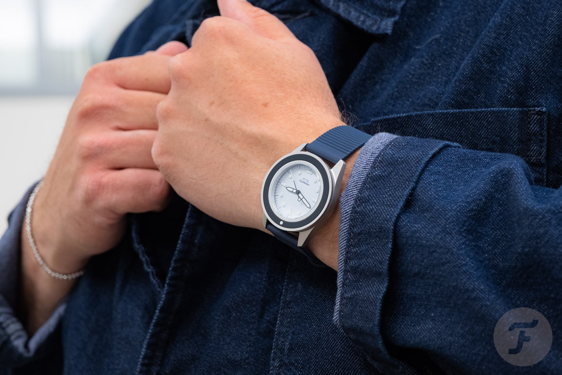 Unimatic Modello Uno UT1-IPP on wrist, hands on lapel