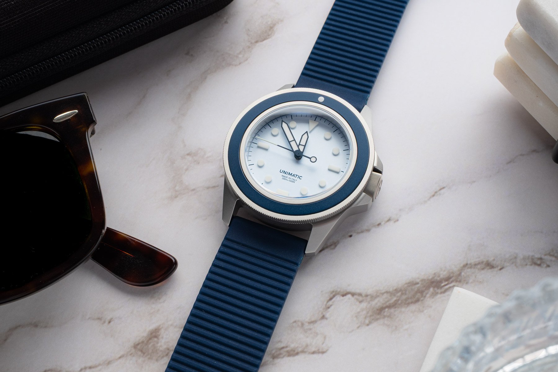 summer watches — Unimatic Modello Uno UT1-IPP flat-lay on white marble surface