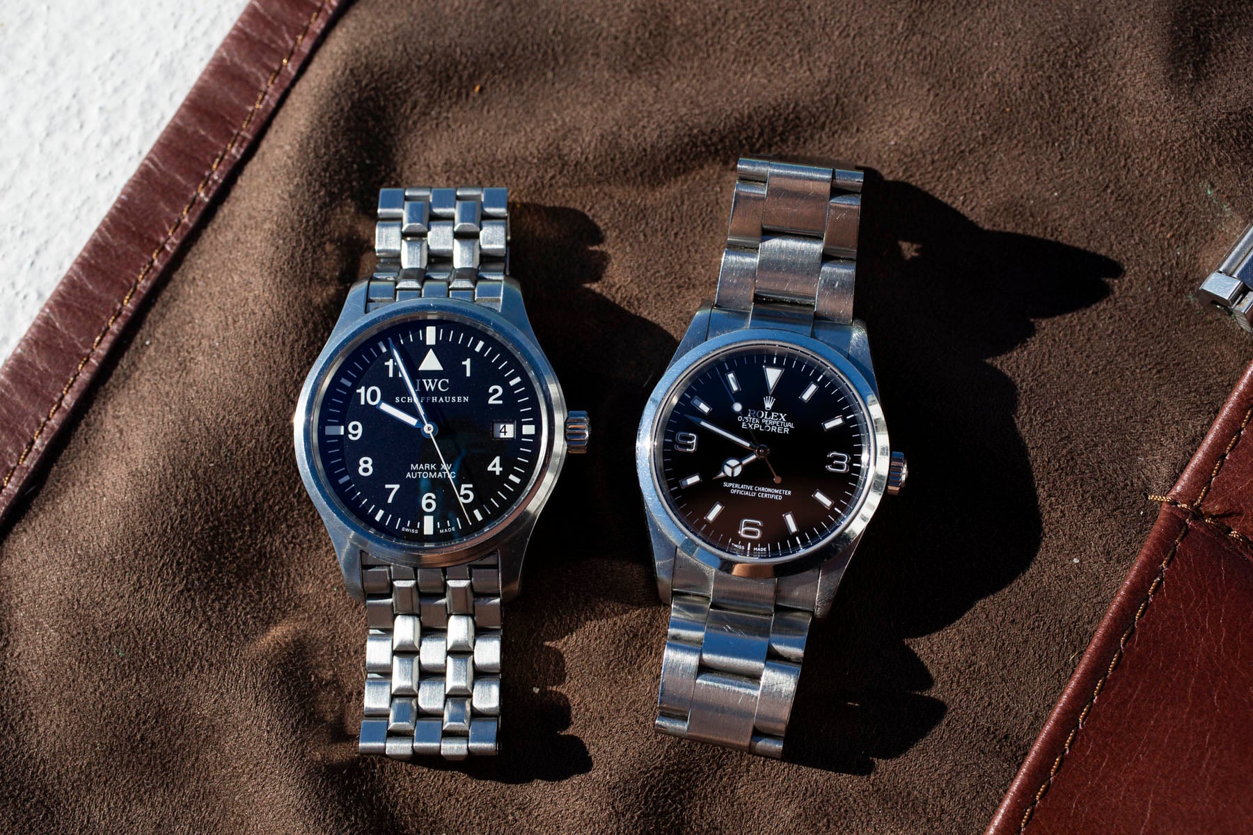 Rolex Explorer ref. 114270 and IWC Mark XV side by side, flat-lay