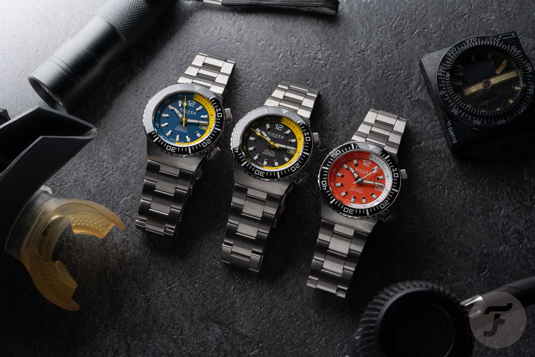 three Sicura Hexa 400 divers lined up, flat-lay