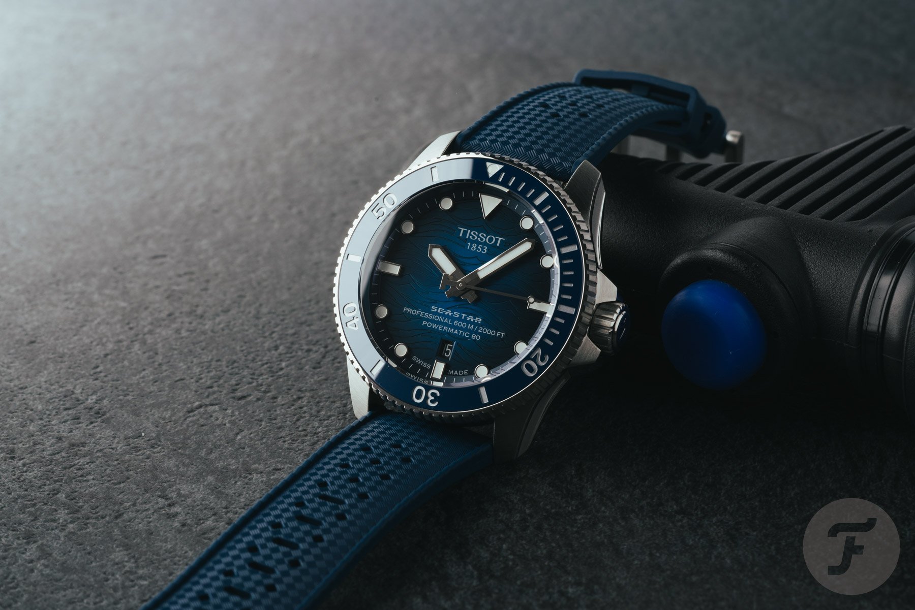 blue-dial version of the sized-down Tissot Seastar 2000 Professional, propped up with strap