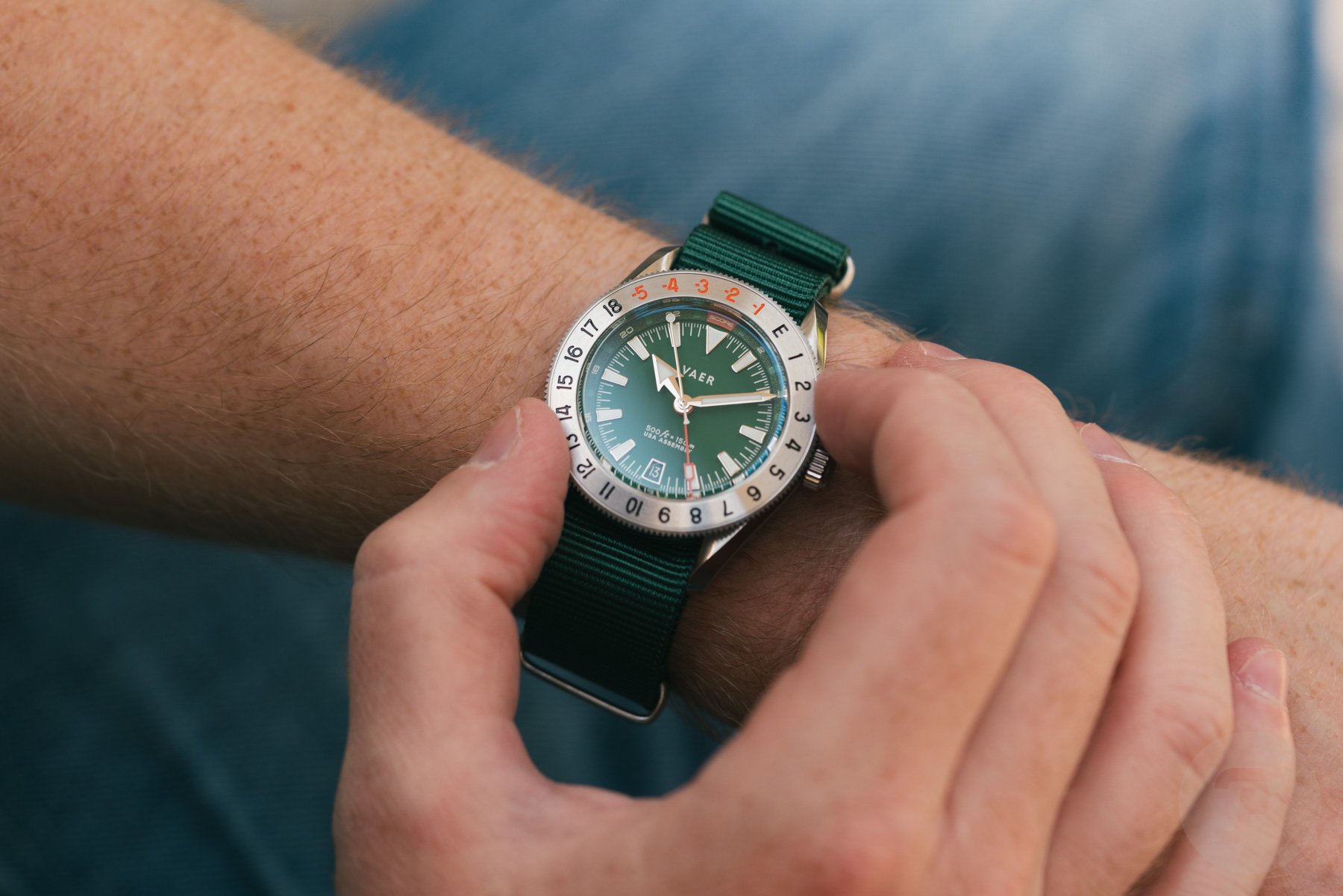 Vaer G2 Fairway GMT on wrist, fingers on bezel