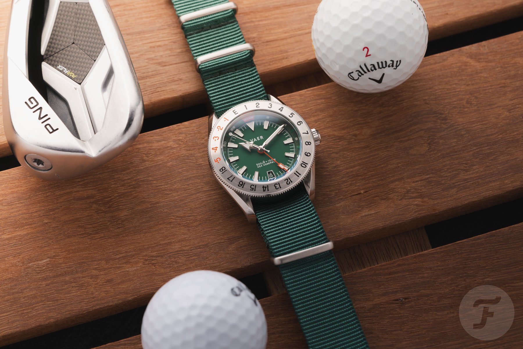 Vaer G2 Fairway GMT flat-lay with golf balls and club