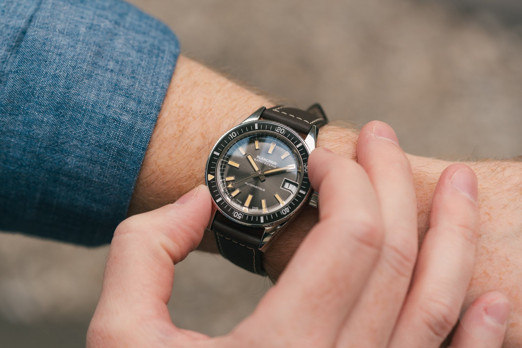 Blancpain Fifty Fathoms Bathyscaphe 70th Anniversary on wrist, fingers on bezel