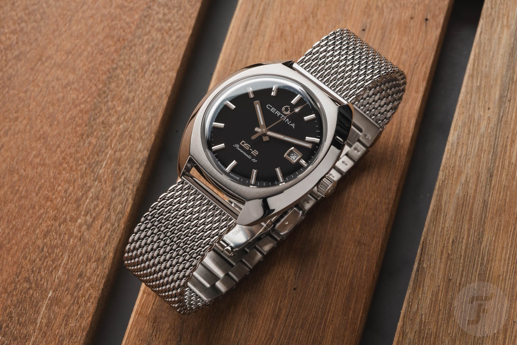 diagonal view of the black-dial Certina DS-2 Powermatic 80 on a mesh bracelet