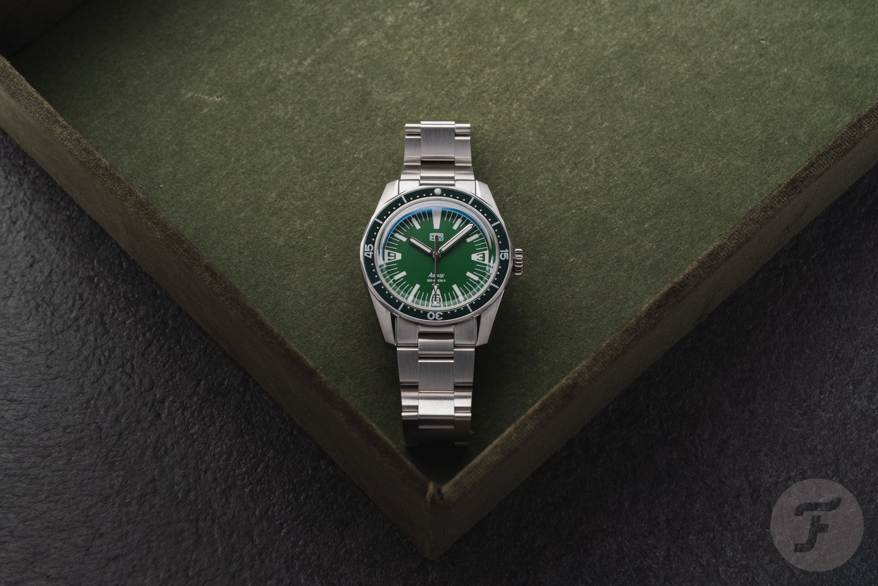 green-dial HTD Aquatìc SpaceBoy flat-lay on watch tray