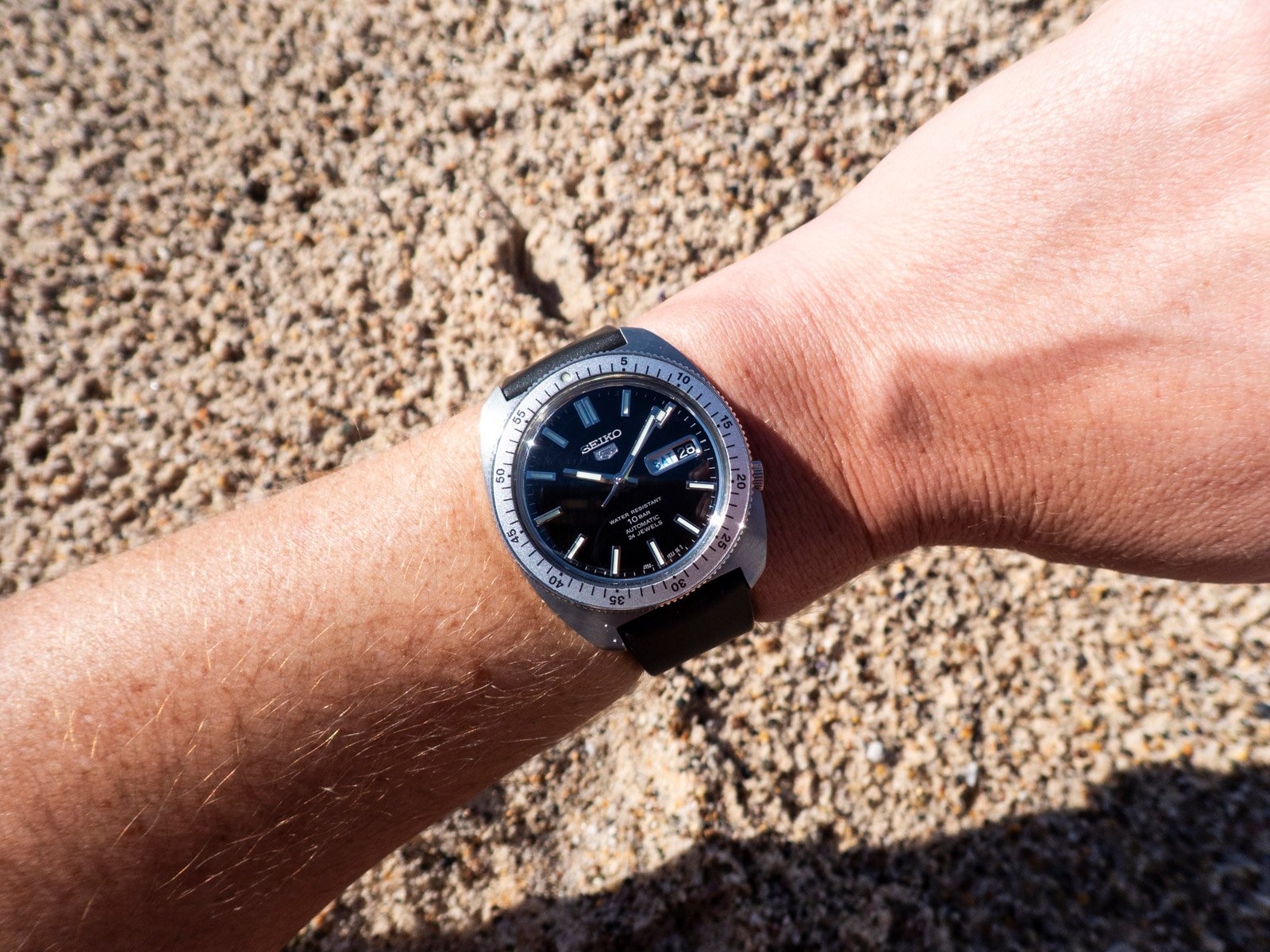 Seiko 5 "Gene Kranz" SRPL93 wrist shot above sand