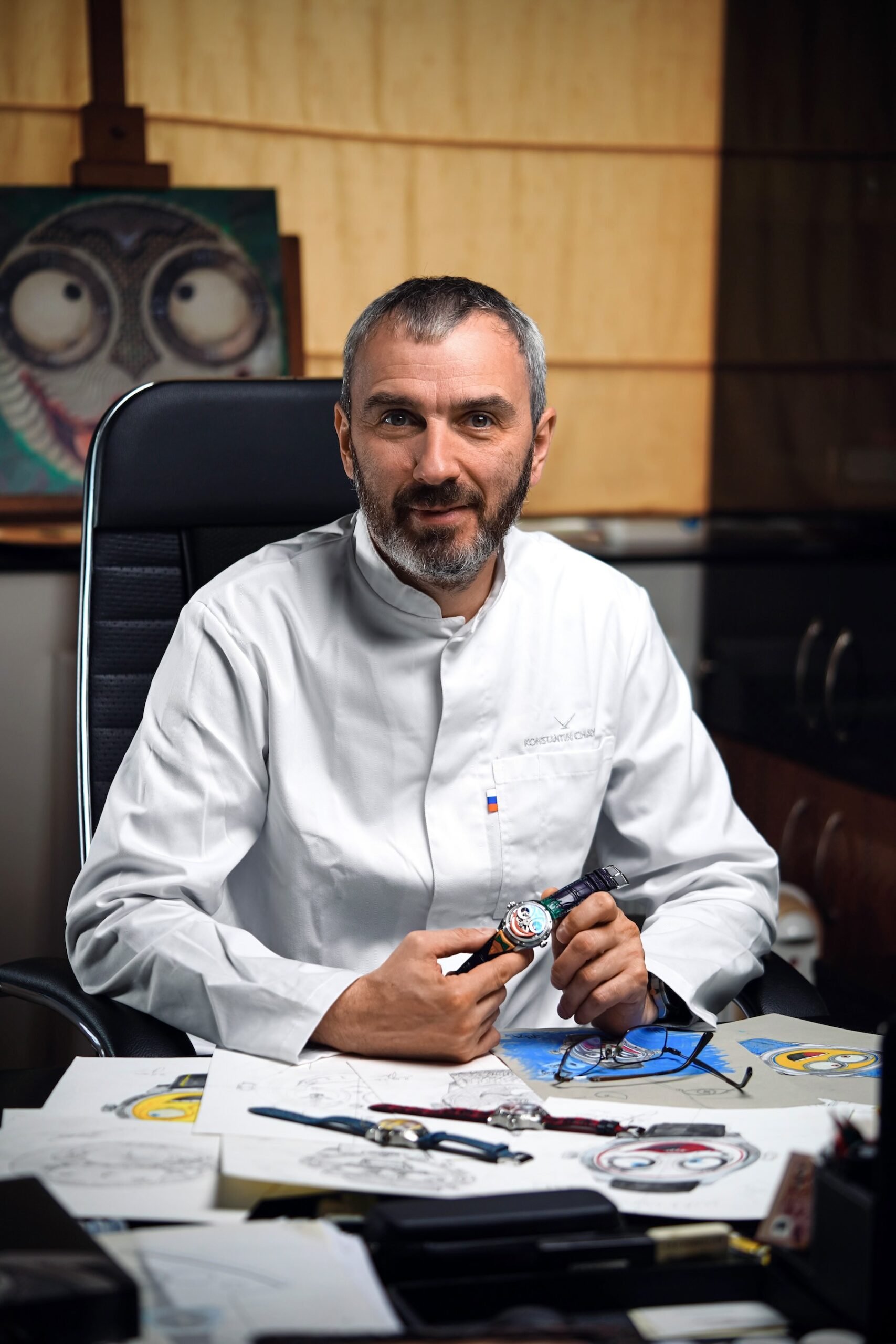 Konstantin Chaykin sitting at desk, holding Joker Five