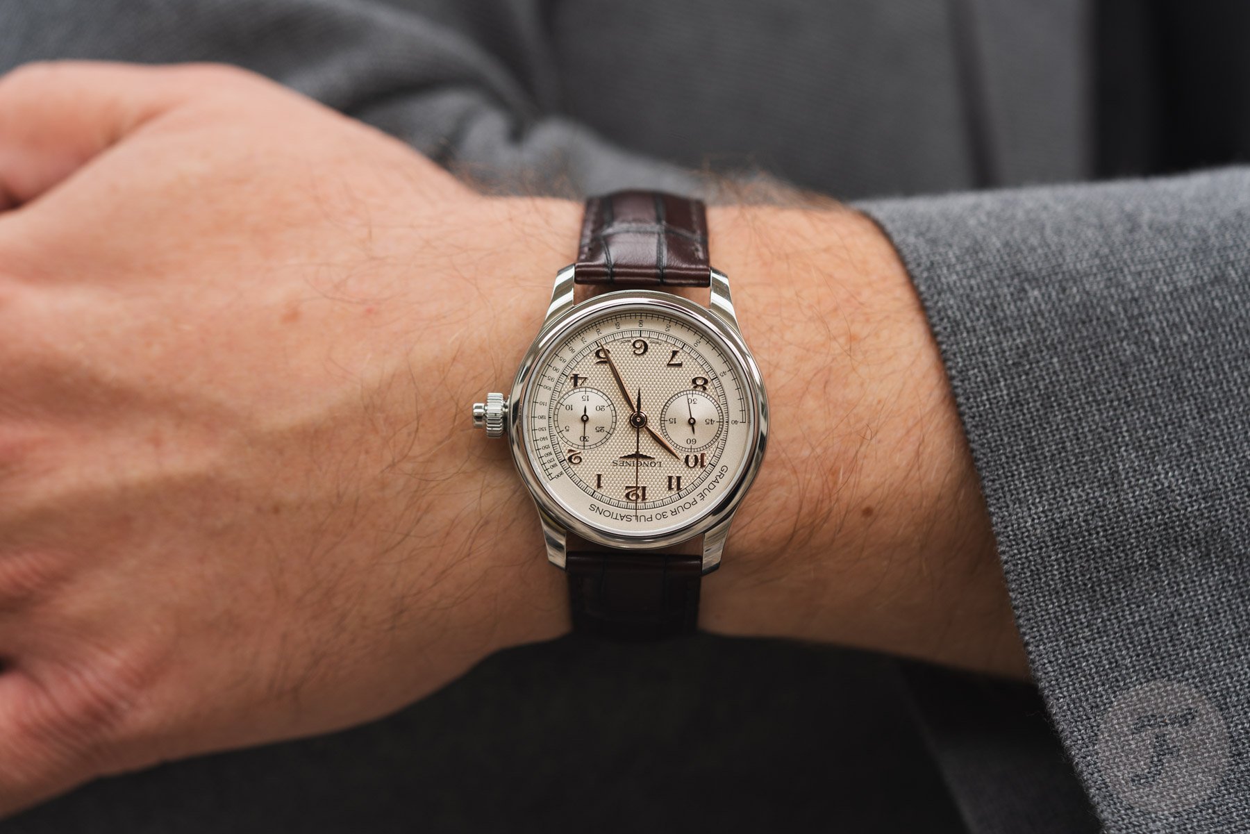 Longines Master Chrono Monopusher on wrist, arms crossed