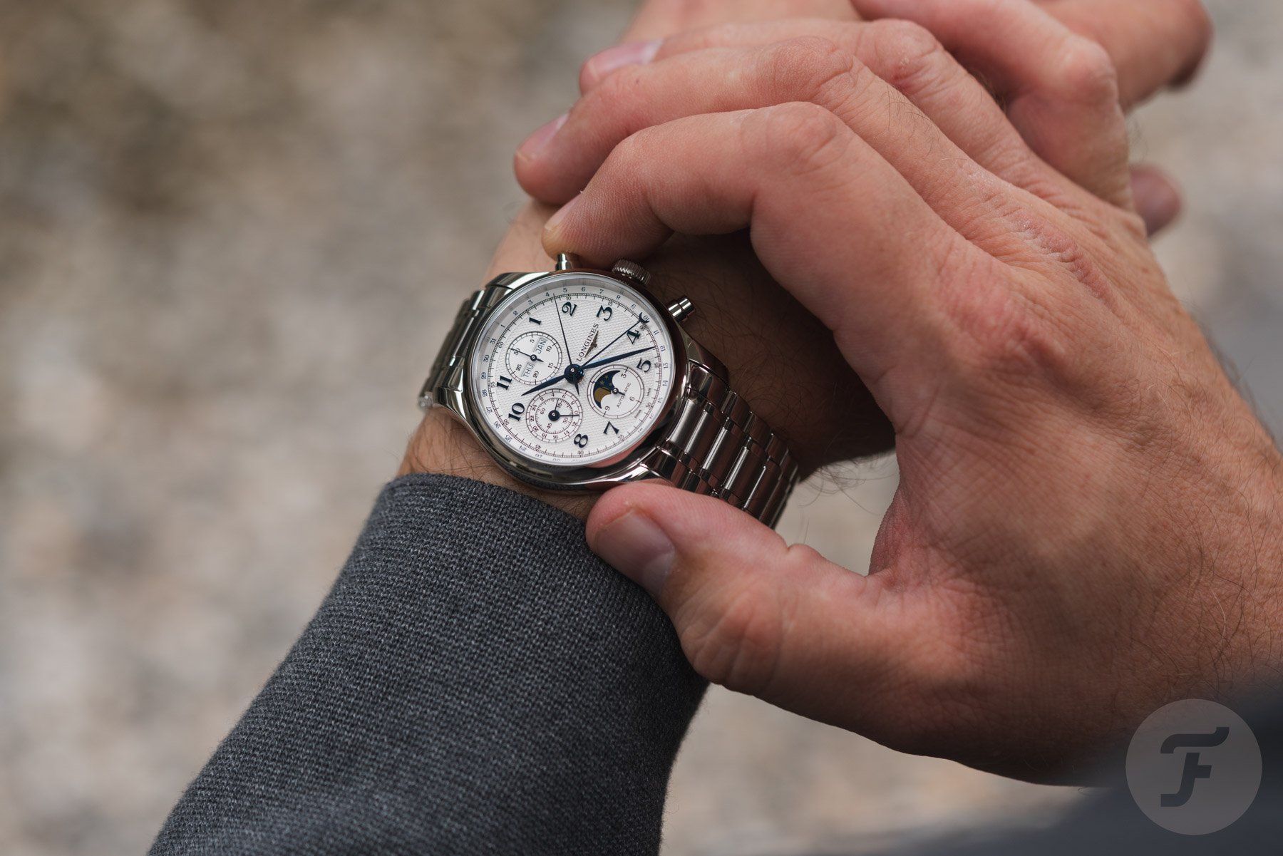 Longines Master Chrono Moonphase on wrist, finger on pusher