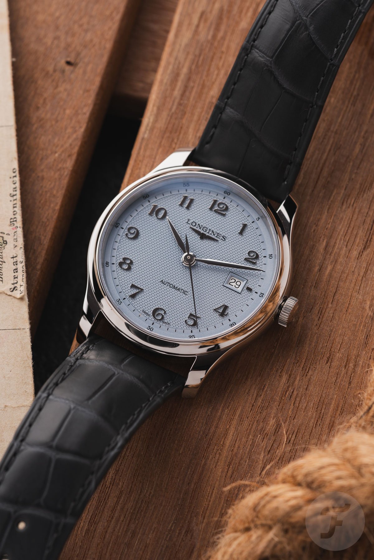 blue-dial Longines Master 41 flat-lay