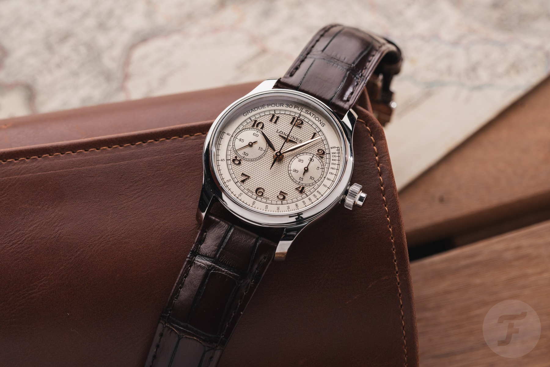 Longines Master Chrono Monopusher flat on leather watch roll