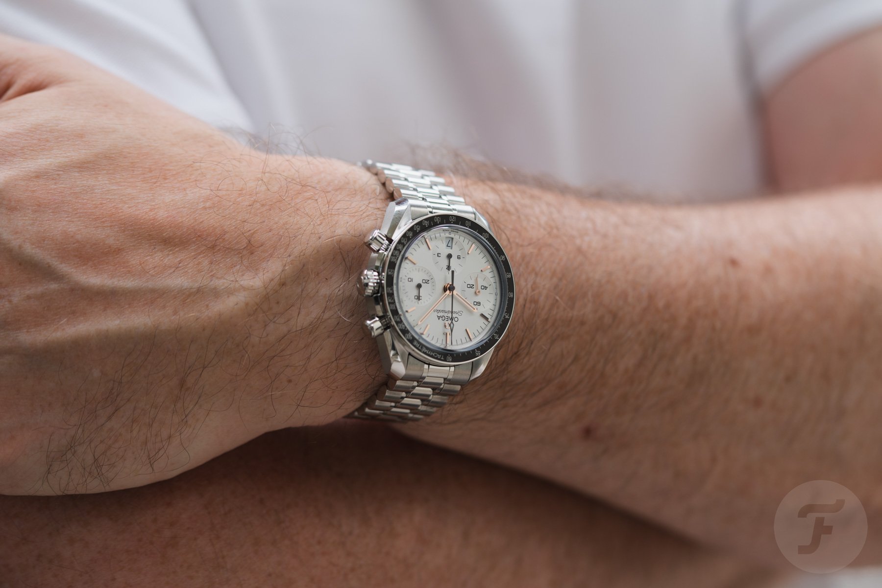 Omega Speedmaster Reduced 324.30.38.50.02.003 on wrist, arms crossed
