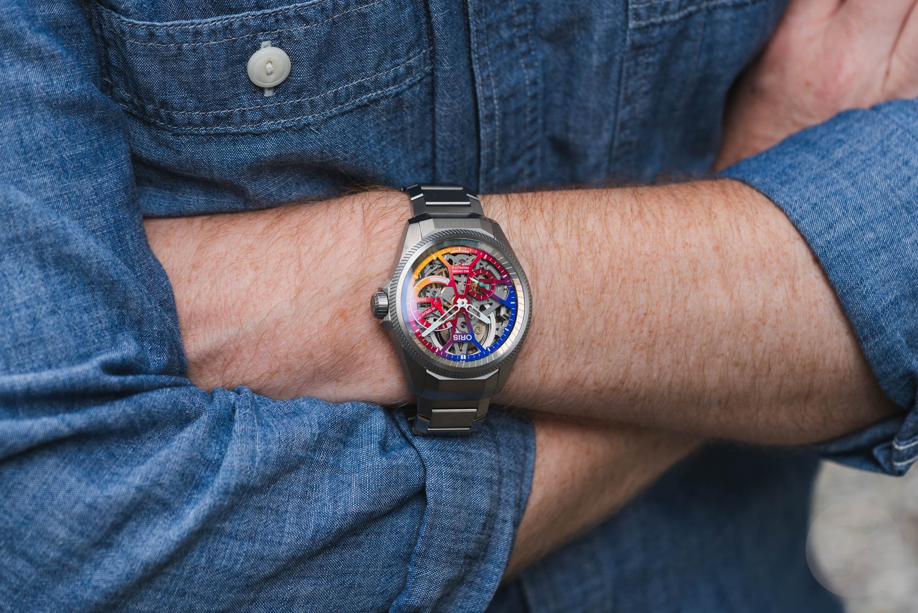 Oris ProPilot X Gonzo Edition on wrist, arms crossed