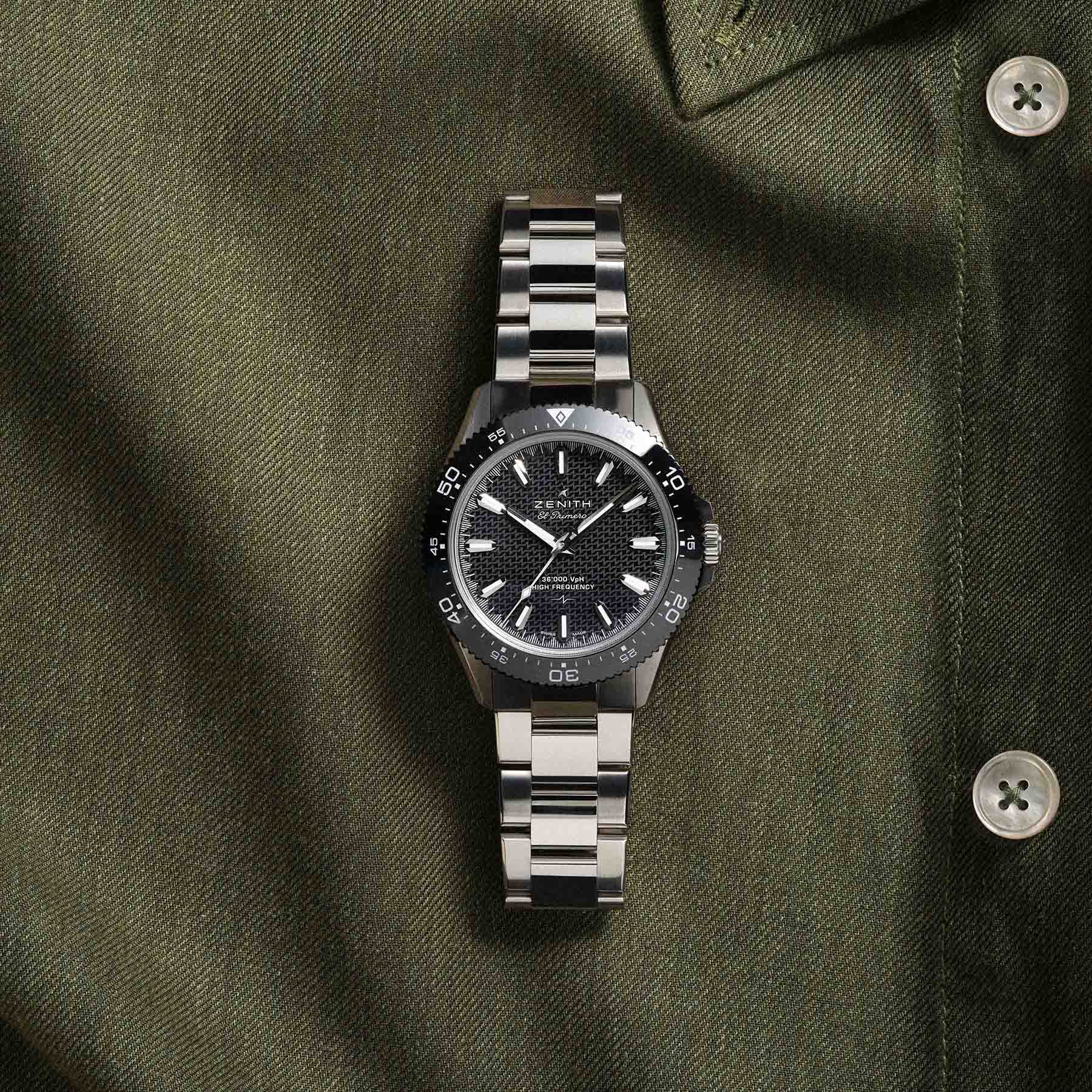 no-date Zenith Chronomaster Solo Sport flat-lay on green shirt