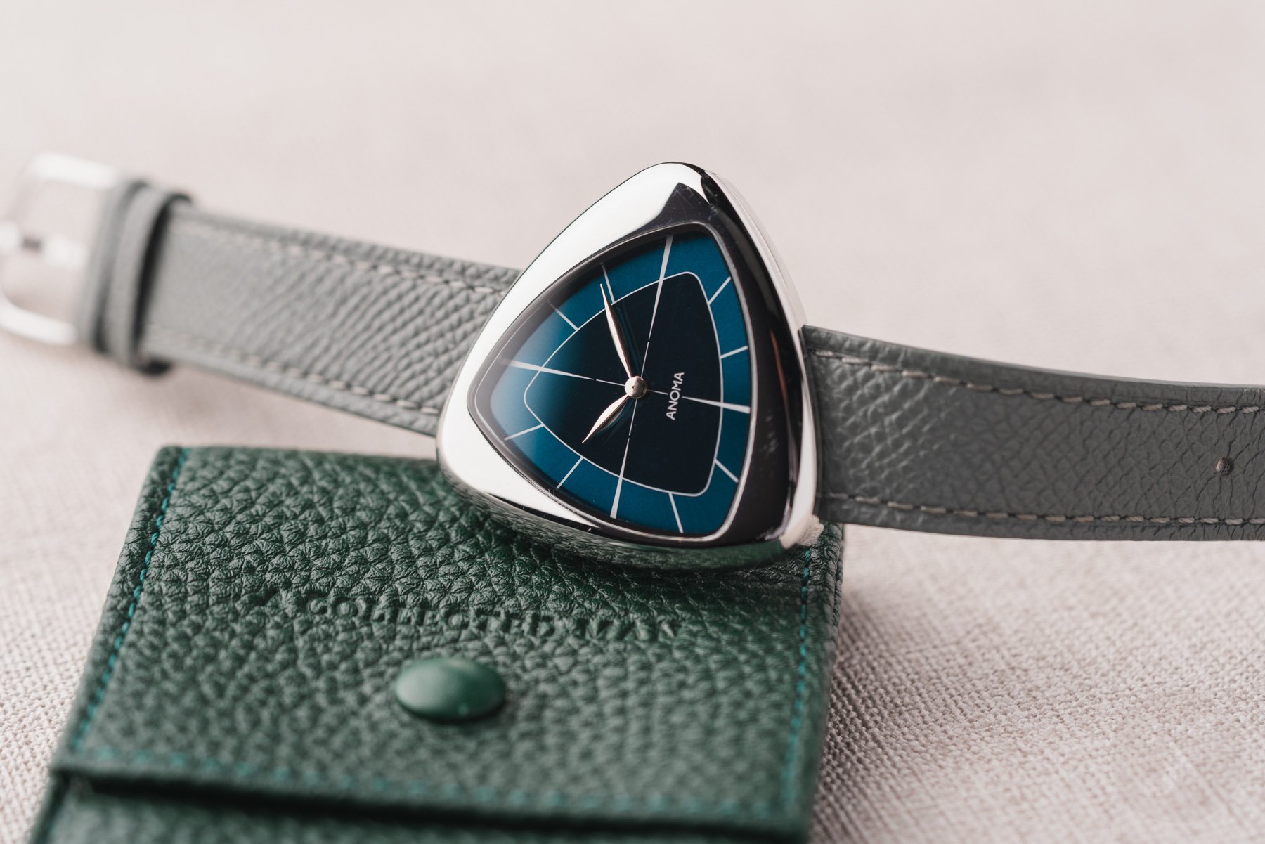 Anoma A1 Core Collection Abyss on its side, crown up, on top of watch pouch