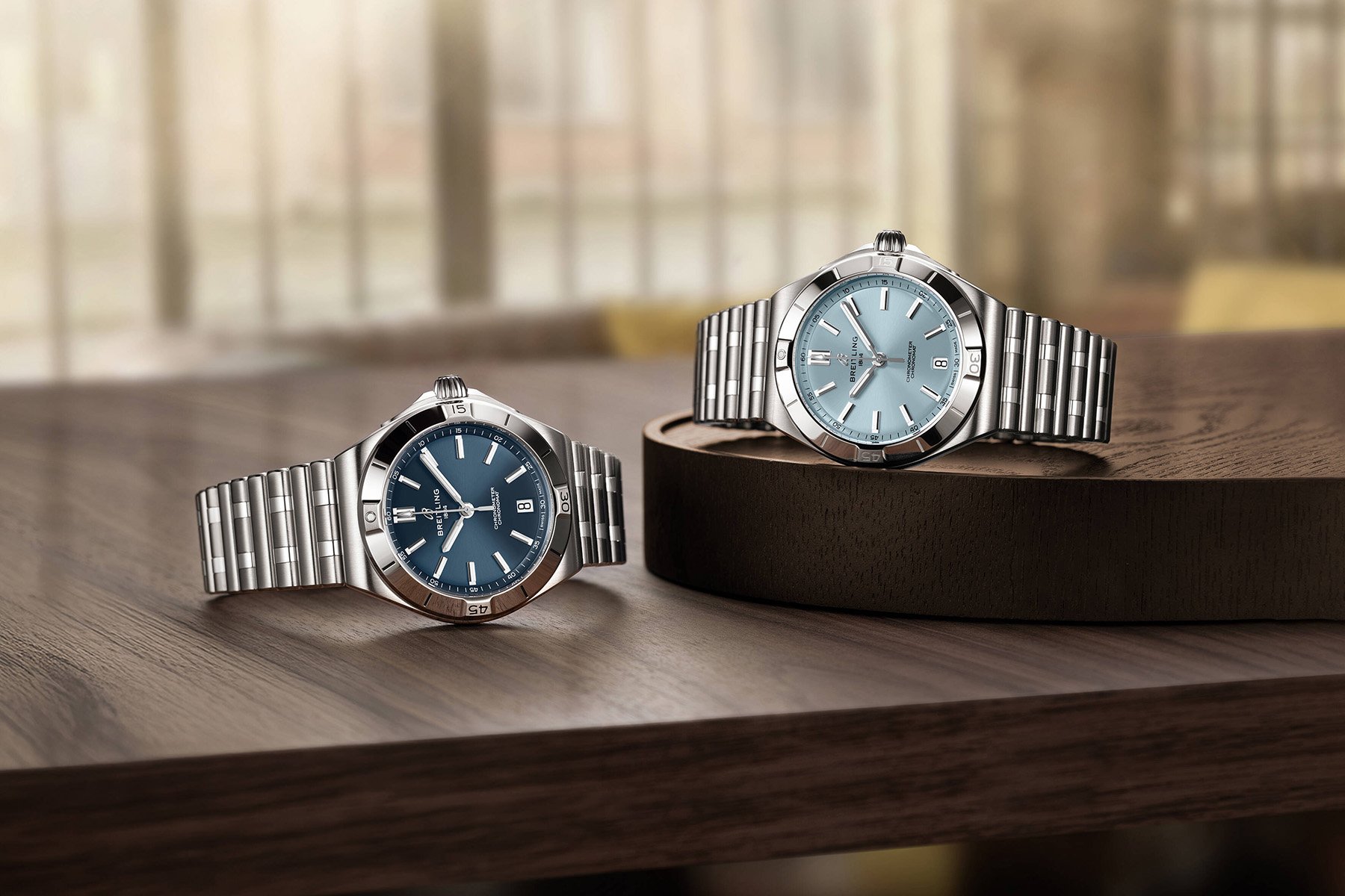 two blue-dial Breitling Chronomat Automatic B31 40 variants, crowns up