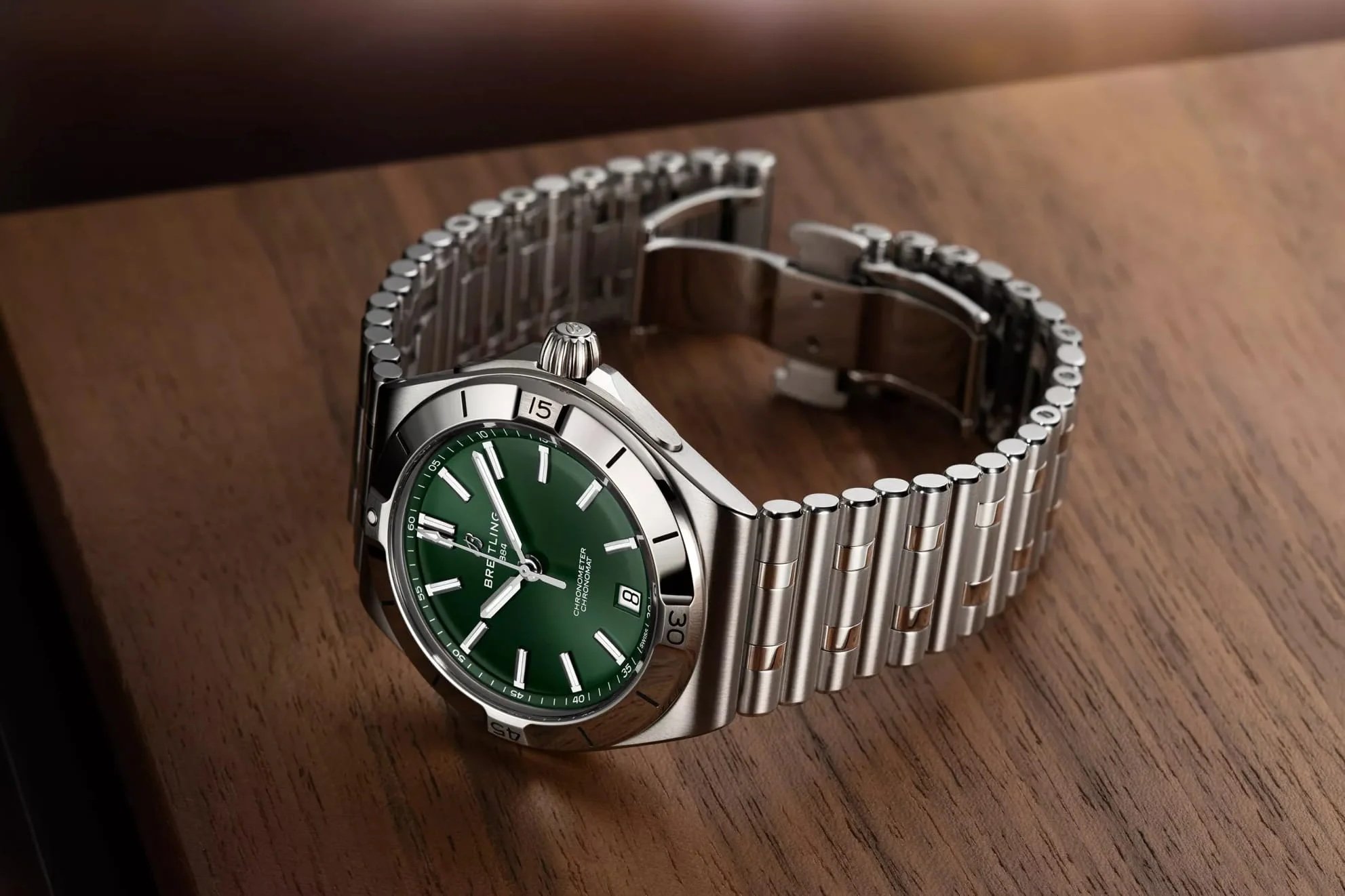 green-dial Breitling Chronomat Automatic B31 40 on its side, crown up