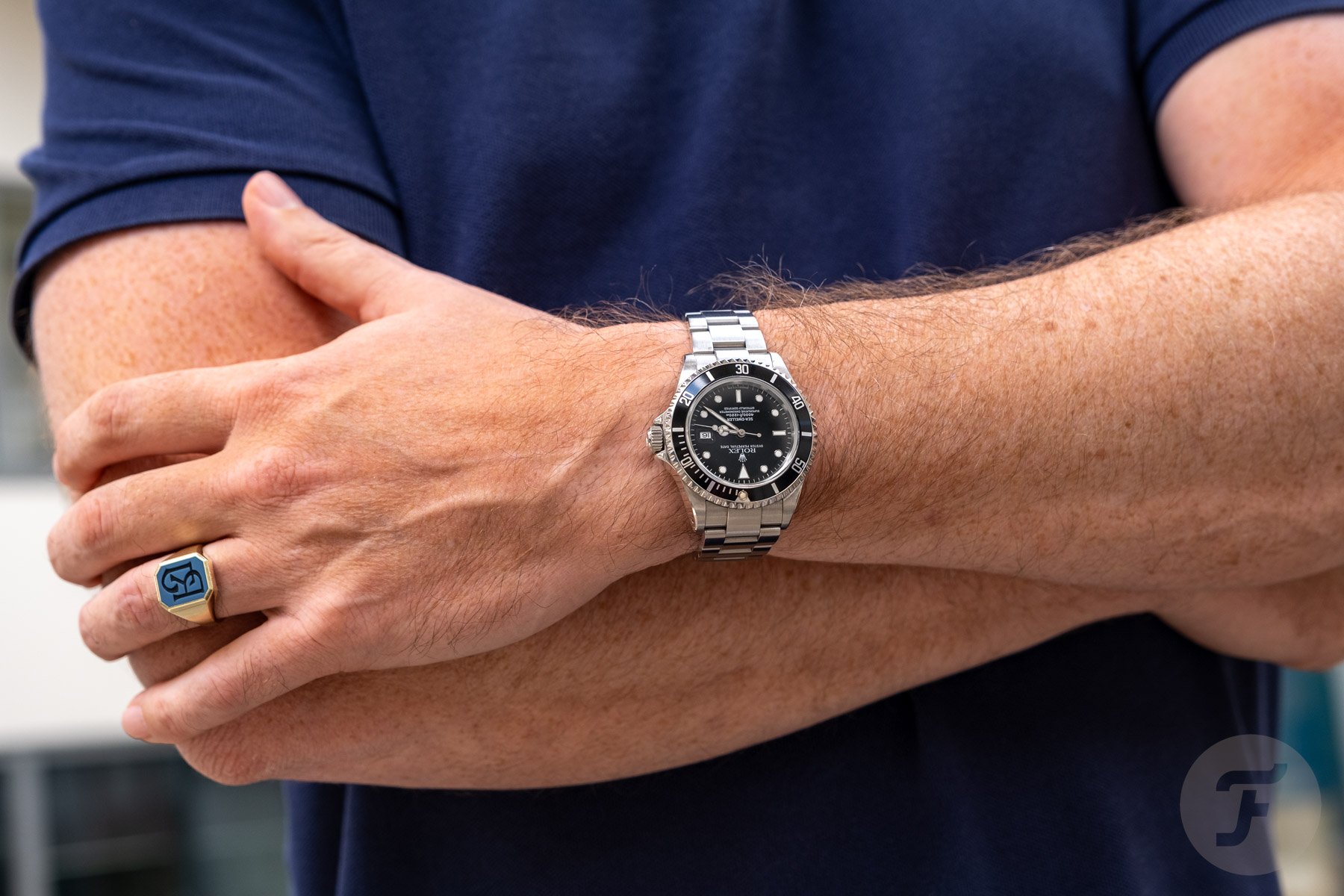 Rolex Sea-Dweller ref. 16600 on wrist, arms crossed