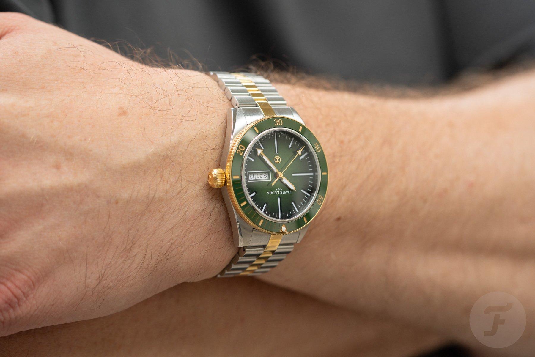 green-dial two-tone Favre Leuba Deep Raider Day Date on wrist, arms crossed