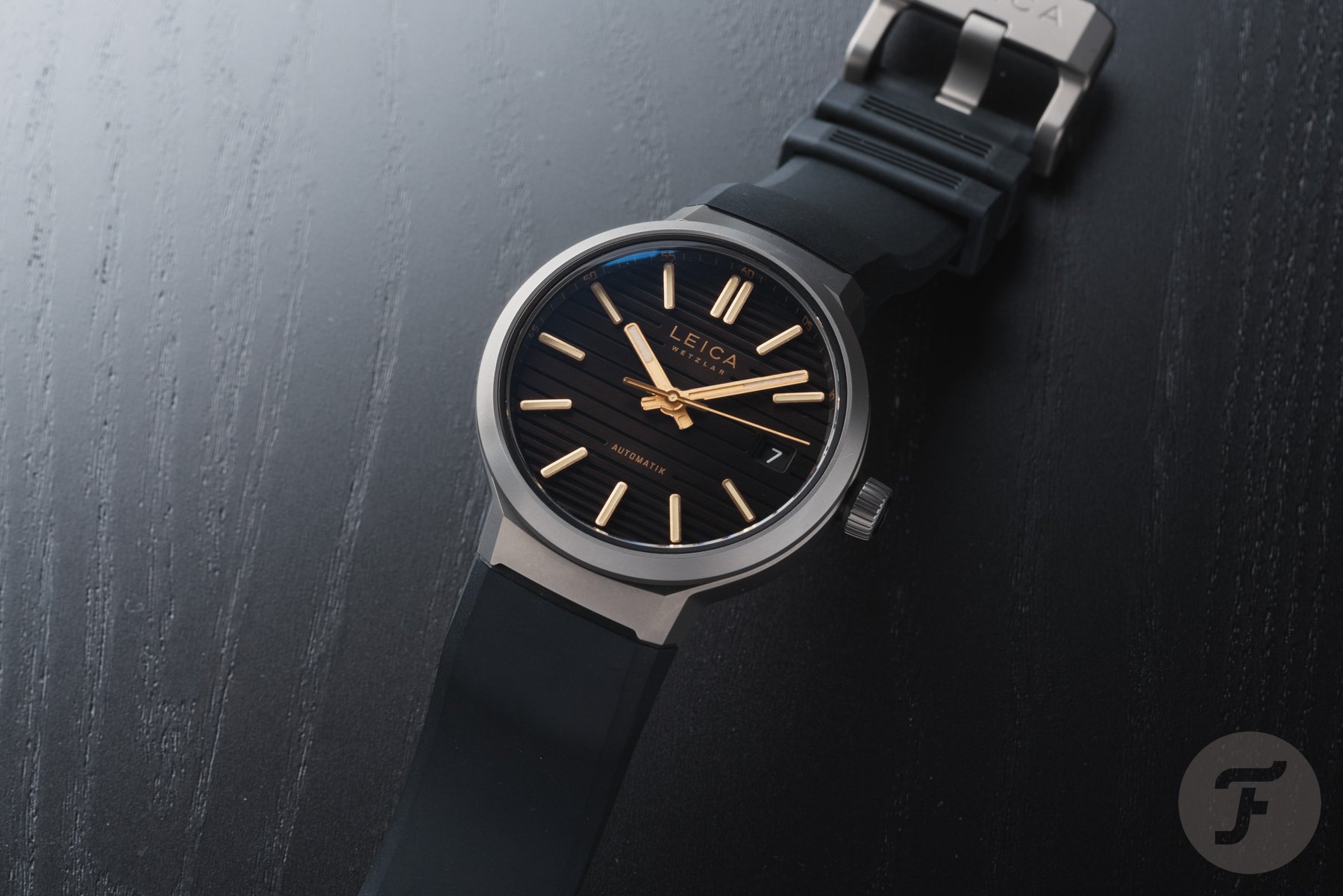 Leica ZM 11 Titanium Coffee Black on rubber strap, overhead view