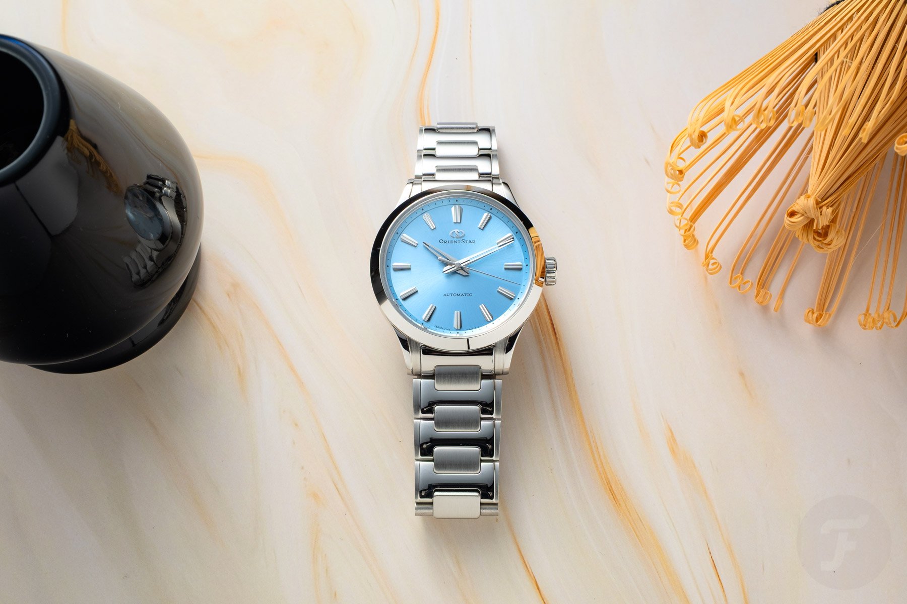 blue-dial Orient Star Sakigake Three Hand flat-lay, head on