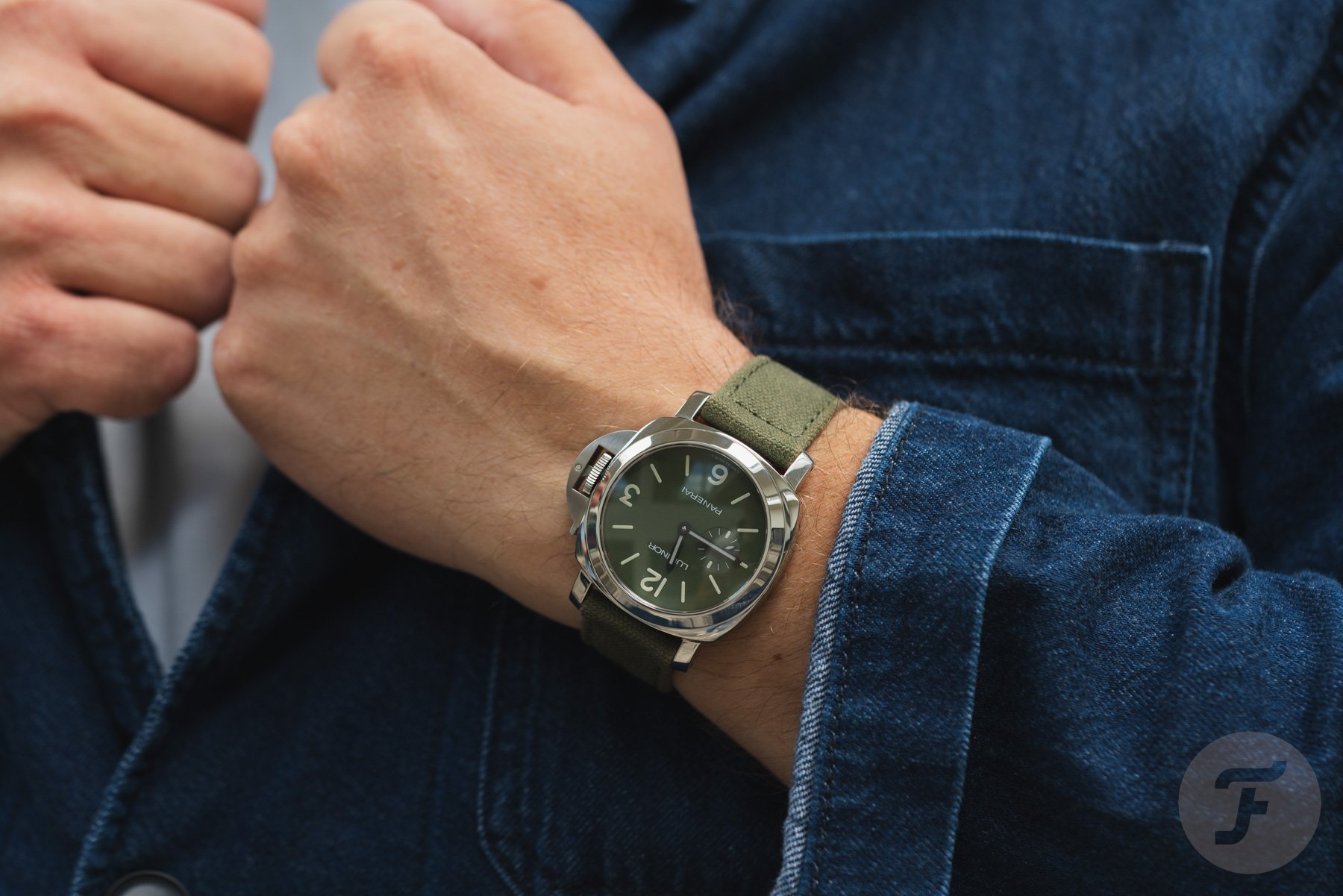 Panerai Luminor PAM01711 on wrist, hands on lapel